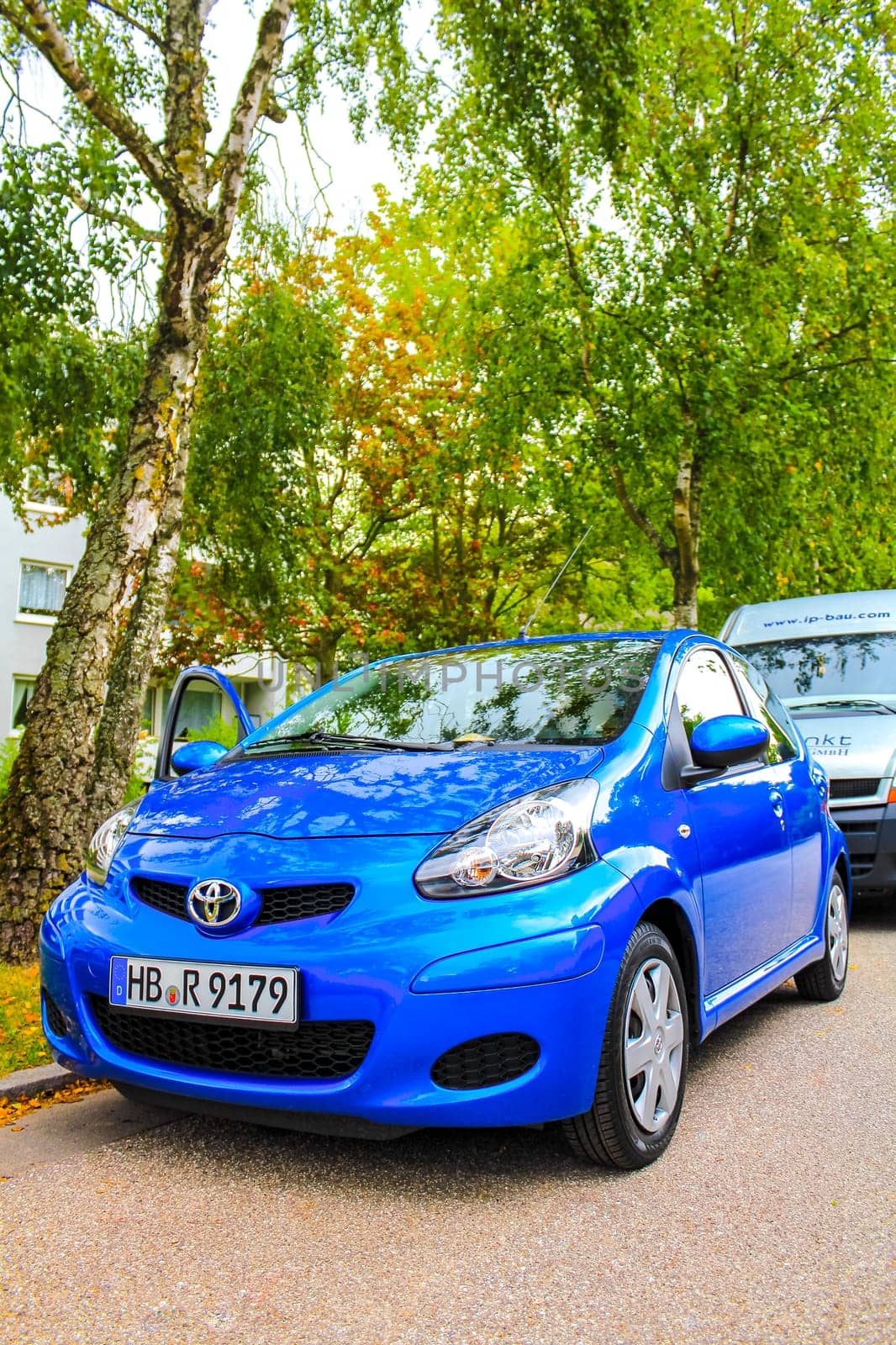 Small blue car vehicle parked in Germany. by Arkadij