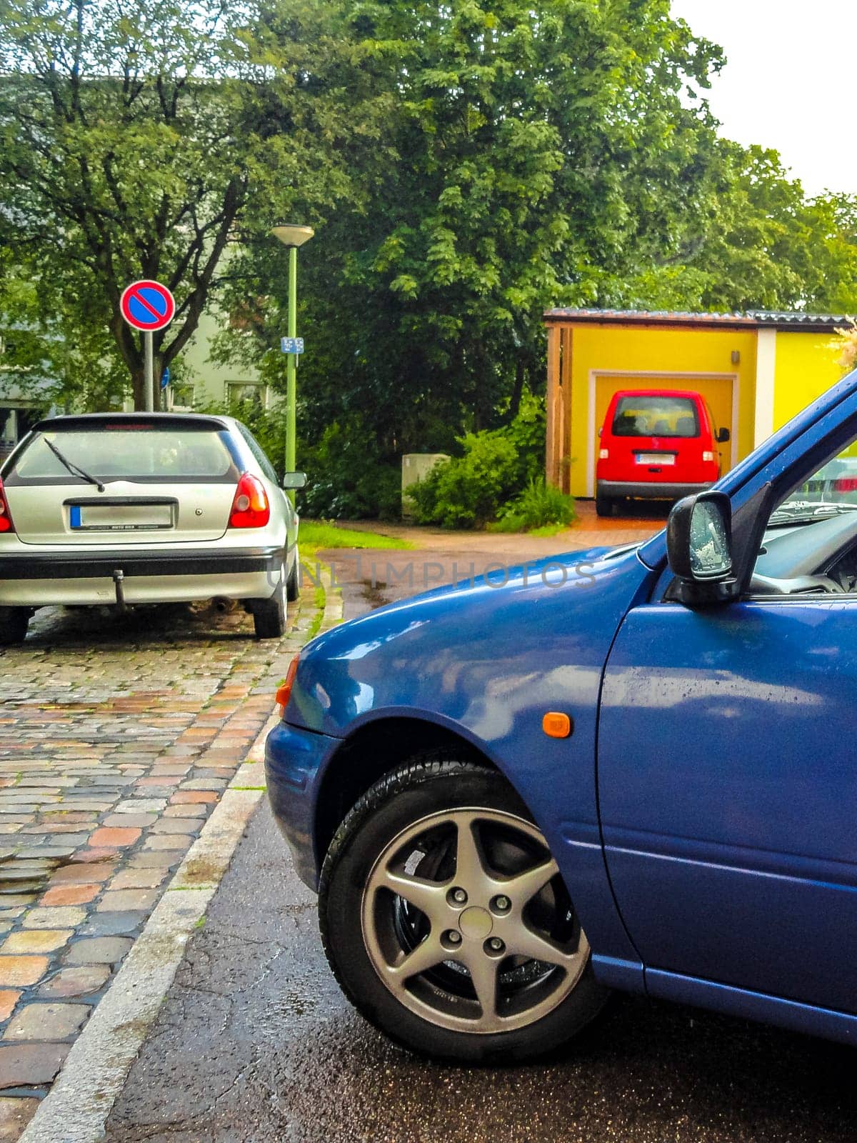 Small blue car vehicle parked in Germany. by Arkadij