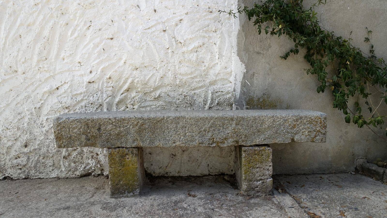 A lgranite bench along the wall of an old abandoned house. by Jamaladeen