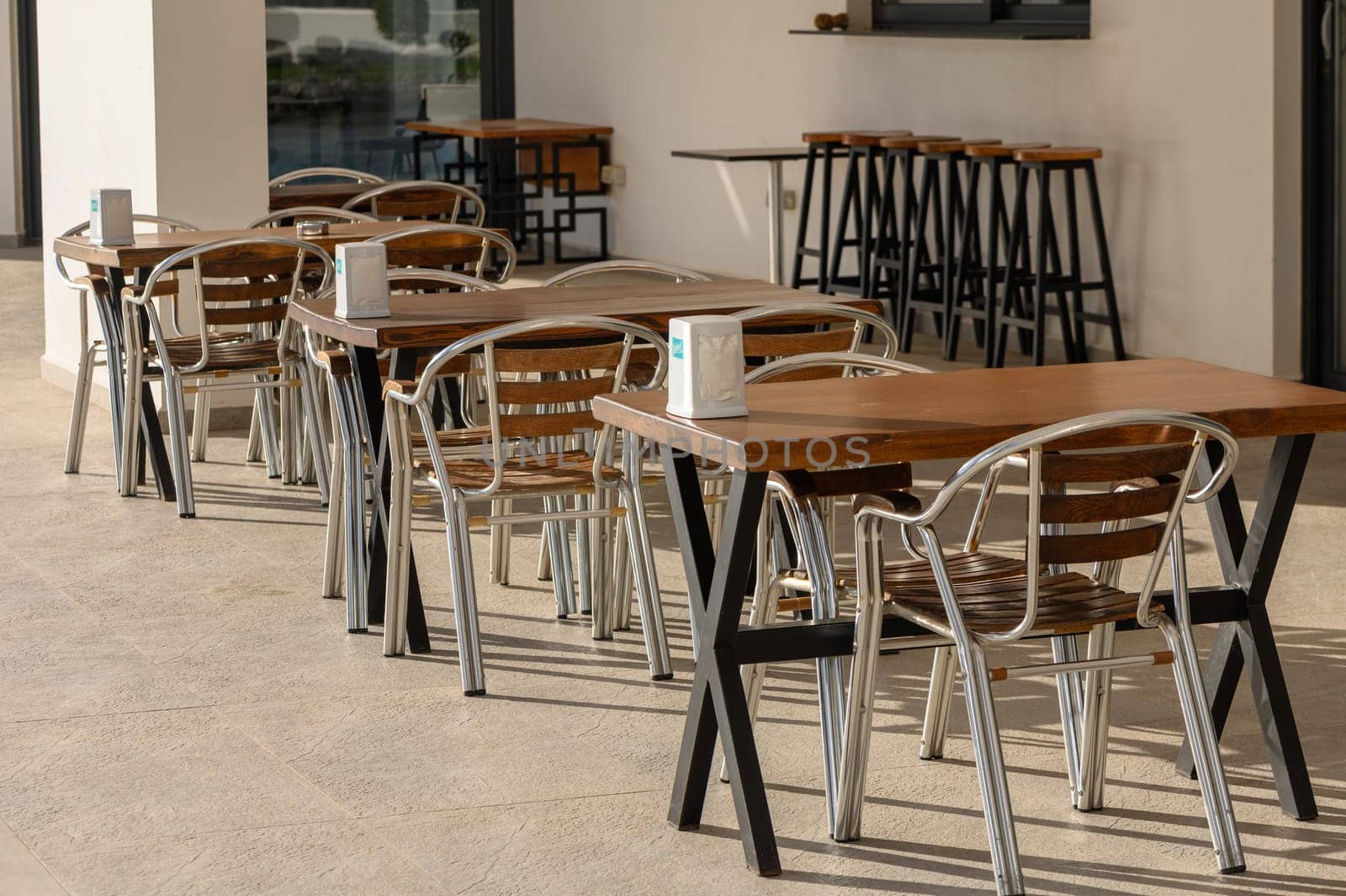 tables in a cafe and swimming pool in a residential complex