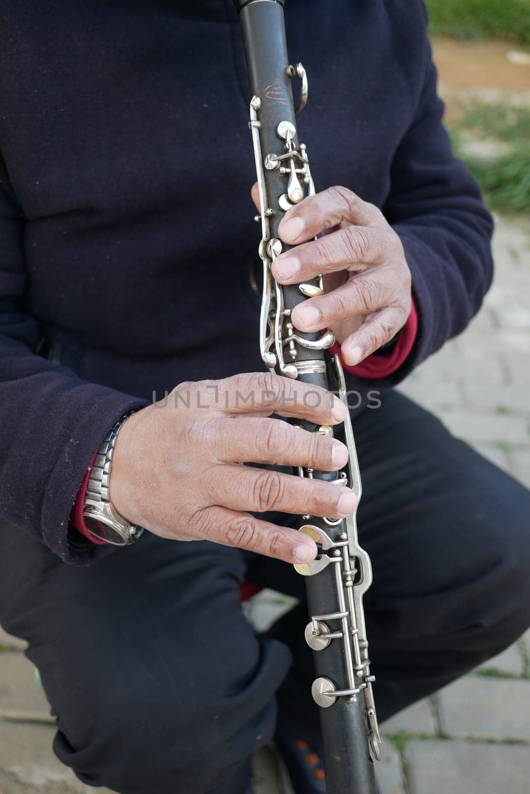 Musician playing on clarinet at street ,