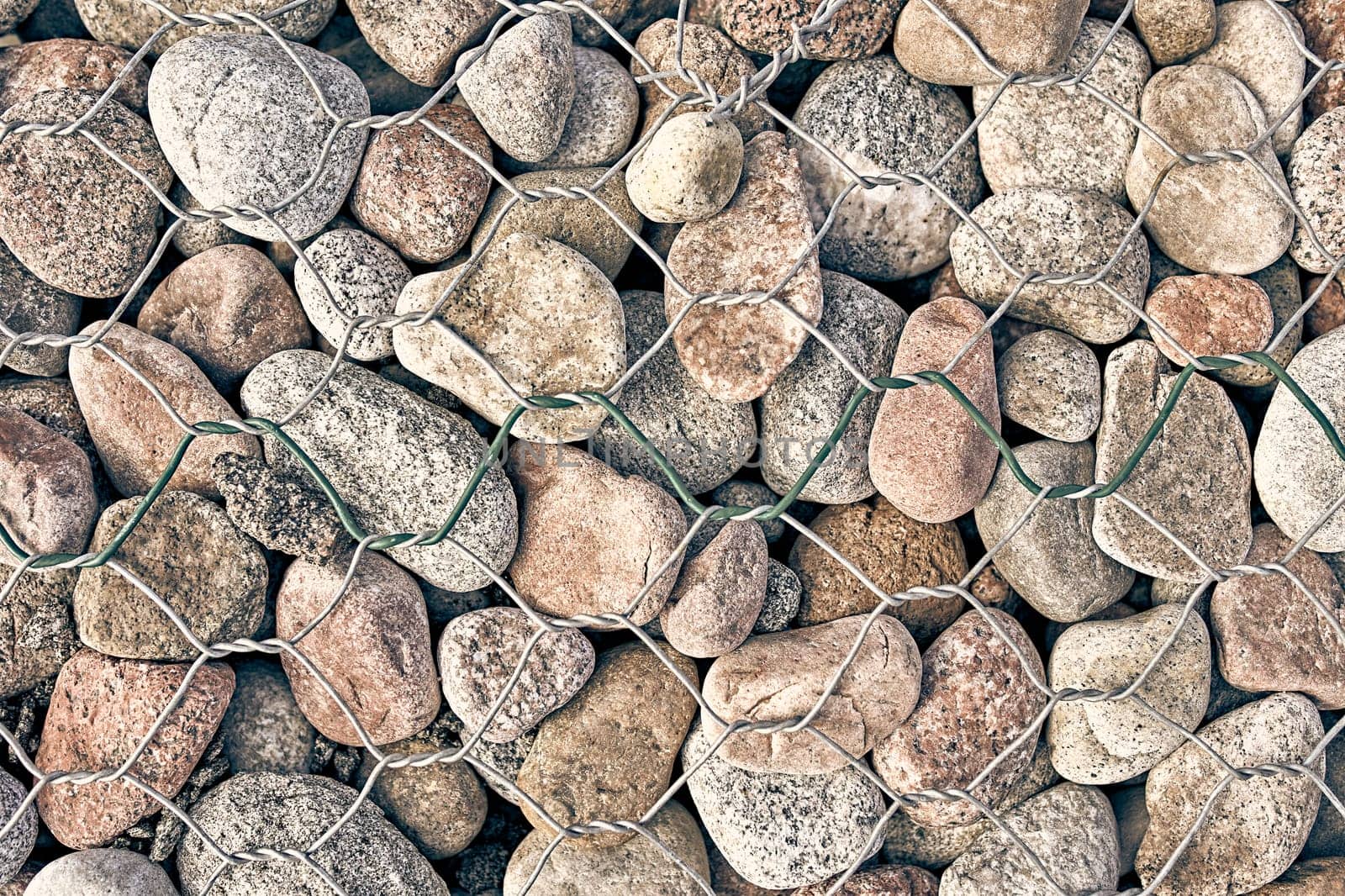 The texture of the rock. Pebble earth and stone for background texture behind bars .