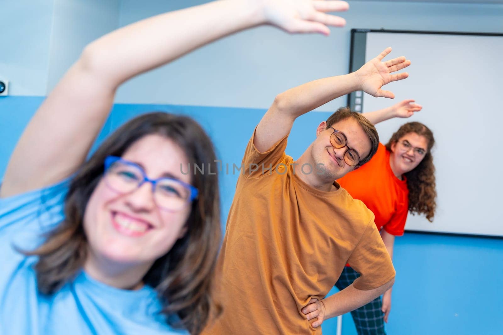 Man with down syndrome and friends enjoying gym class by Huizi