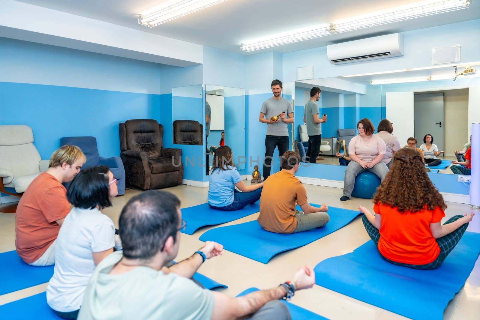 People with special needs in a yoga class by Huizi