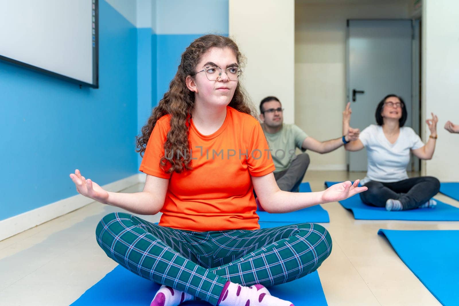 Disabled woman in lotus position during yoga class by Huizi