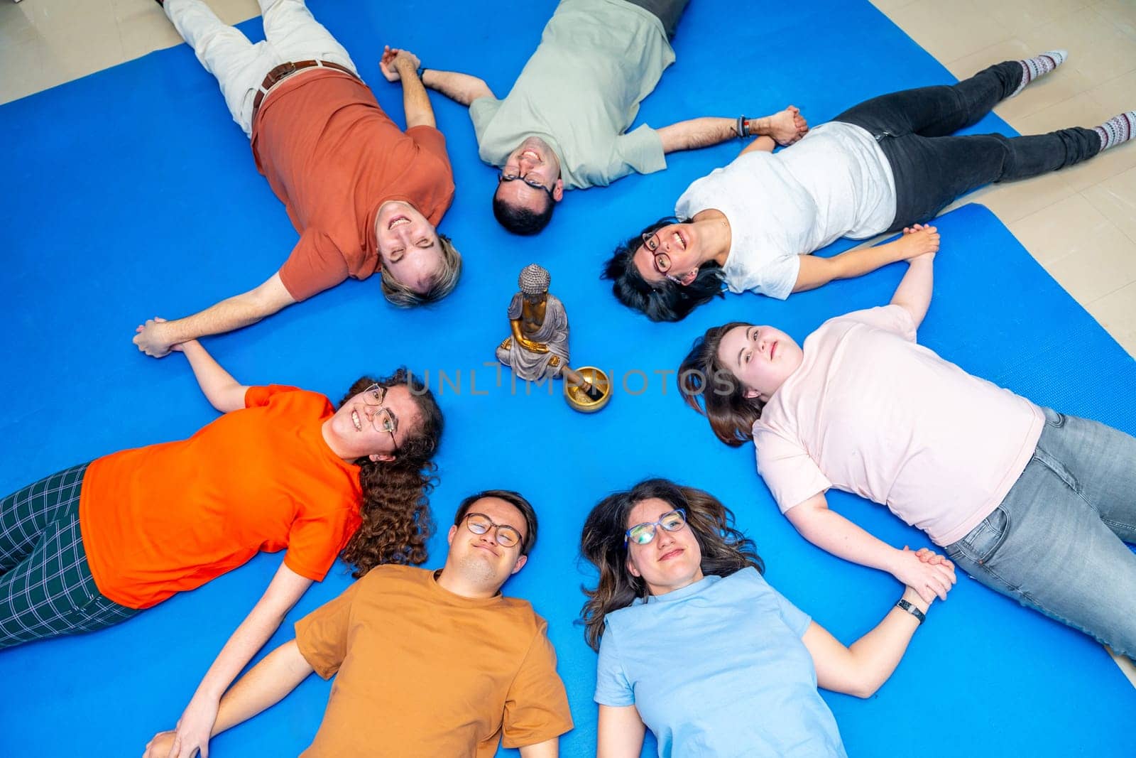 Disabled people lying on the floor meditating together by Huizi