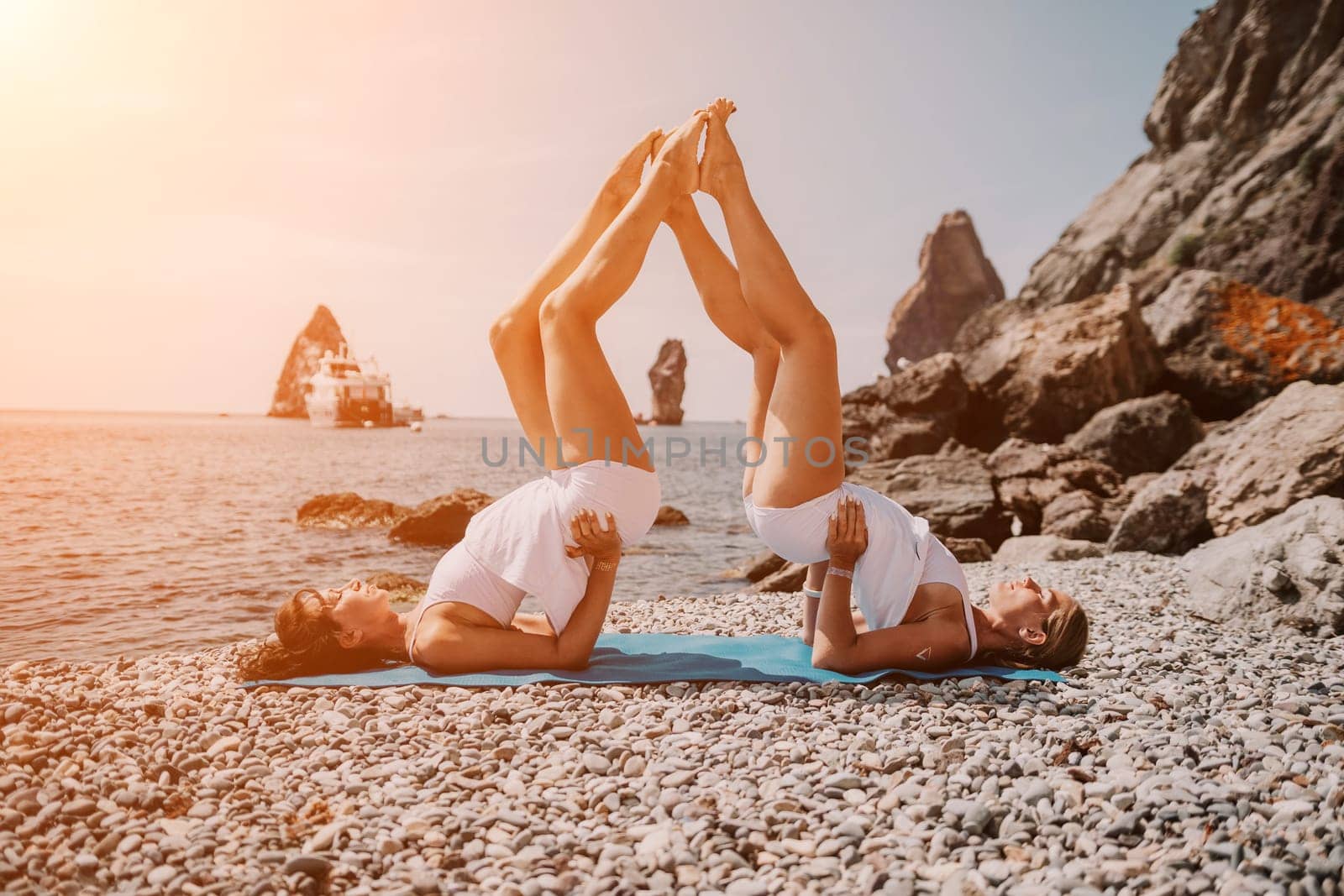 Woman sea yoga. Back view of free calm happy satisfied woman with long hair standing on top rock with yoga position against of sky by the sea. Healthy lifestyle outdoors in nature, fitness concept.