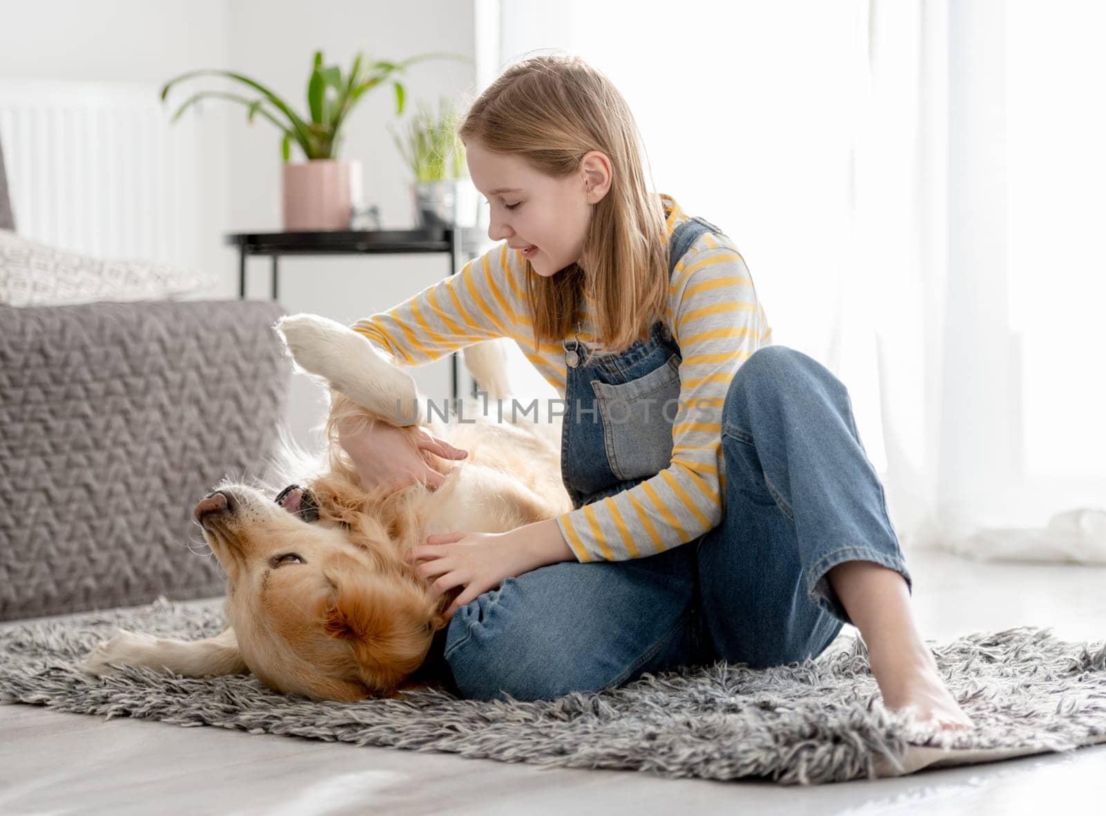 Girl Playing With Golden Retriever On Room Floor by tan4ikk1