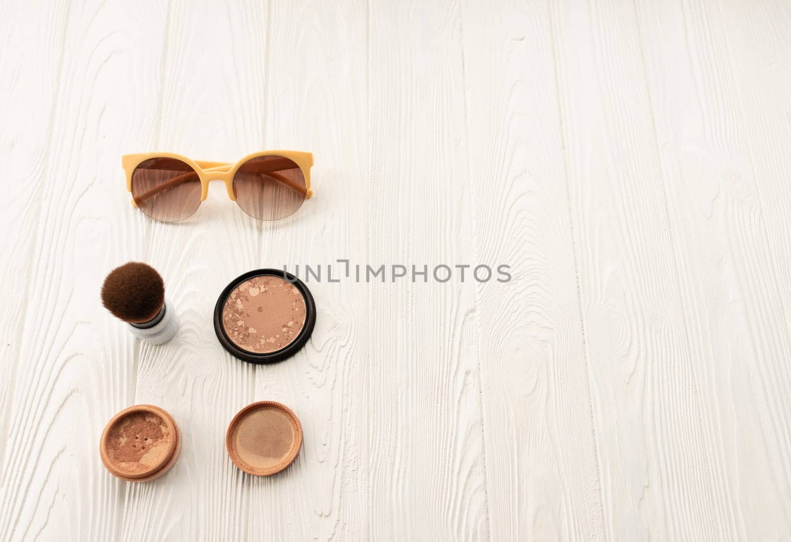 Top sunglasses beige makeup brush powder decorative cosmetic. Summer background mockup template text. top view above white wooden background Summer fashion accessories. Women summer Vacation concept