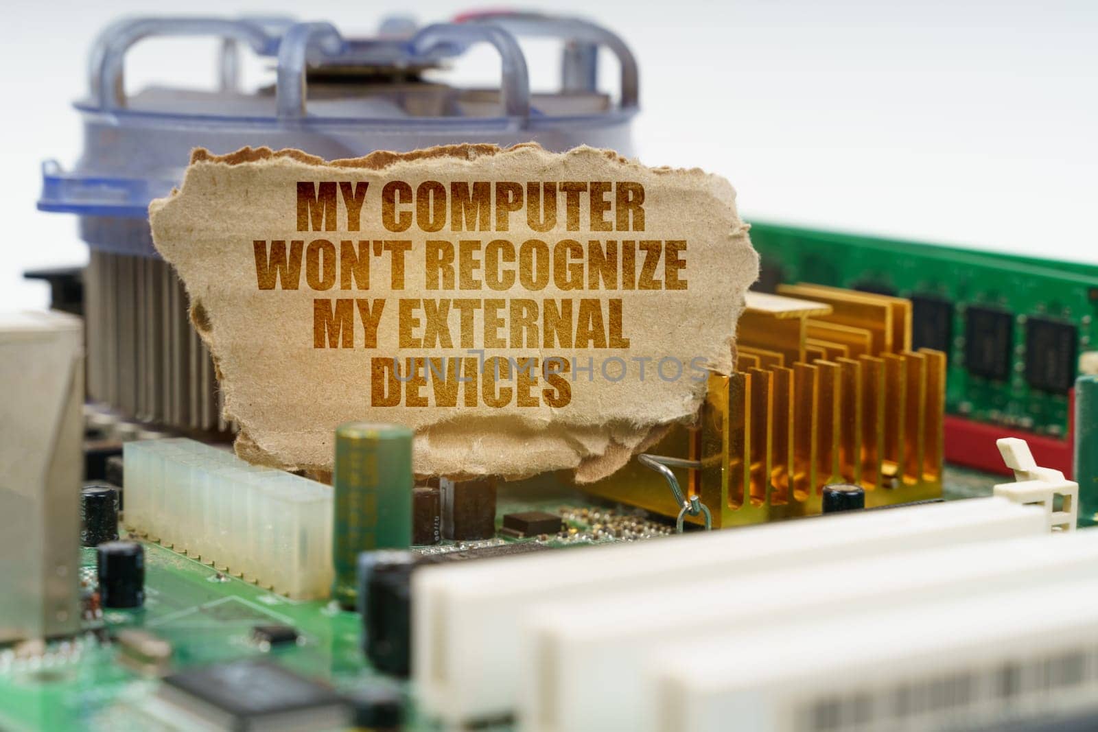 On the computer motherboard there is a cardboard with the inscription - My computer won't recognize my external devices. Computer repair concept.