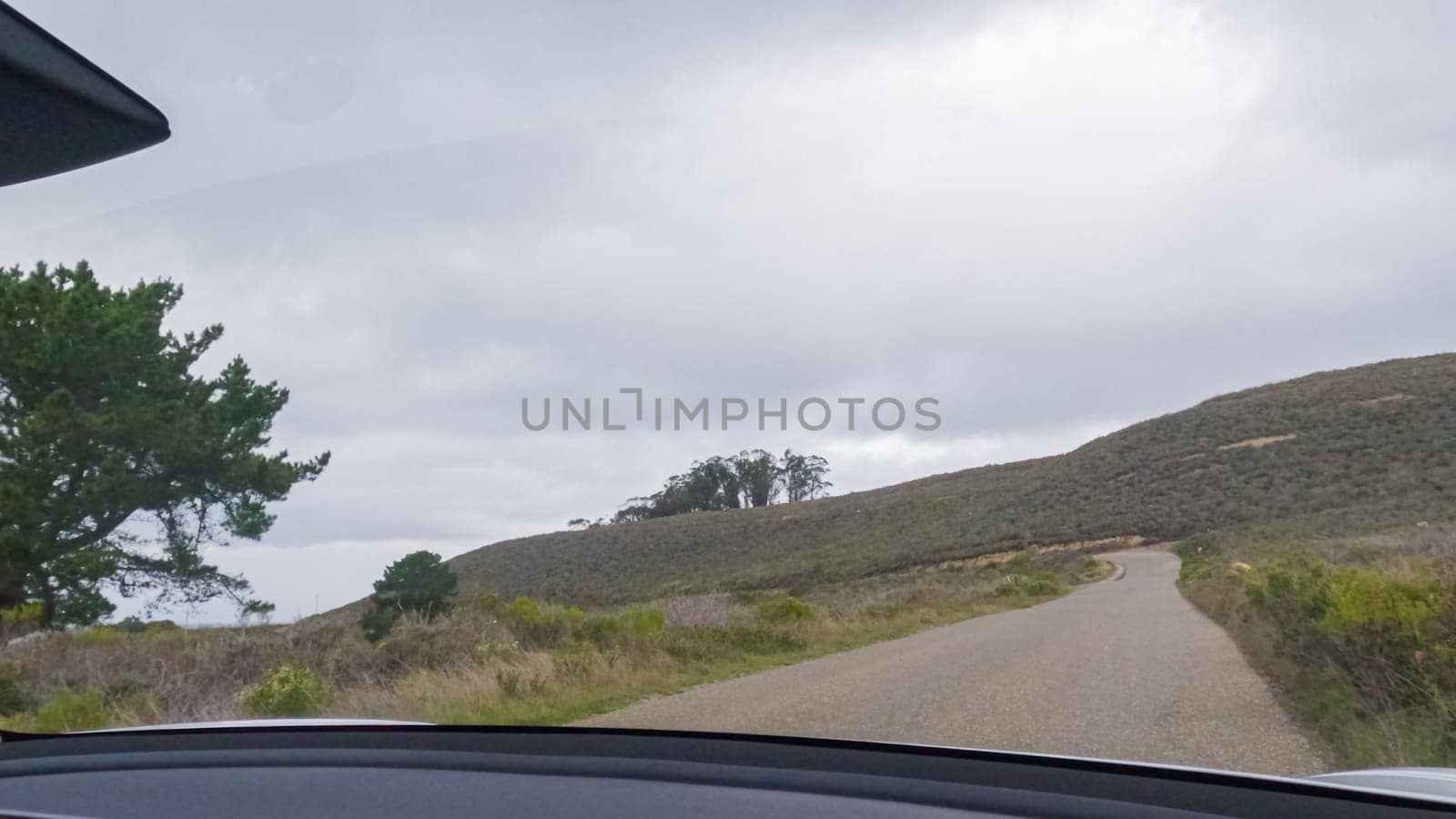 In this serene winter scene, a vehicle carefully makes its way along Los Osos Valley Road and Pecho Valley Road within Montana de Oro State Park.