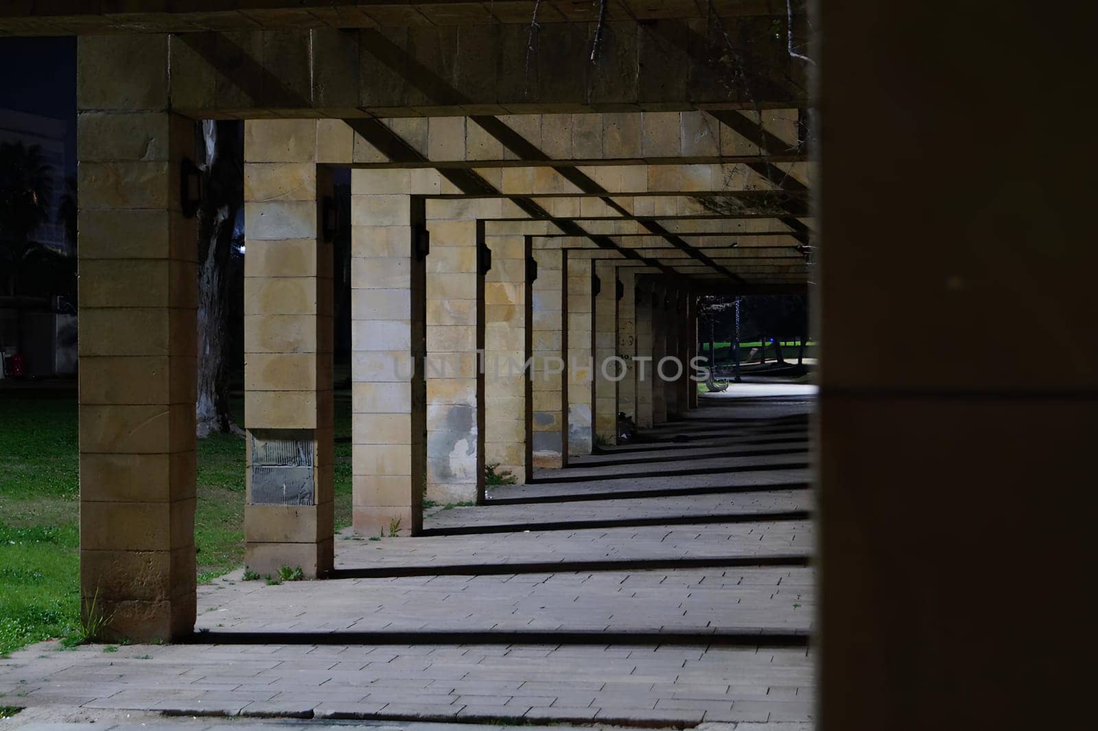 A long, empty hallway with a few pillars