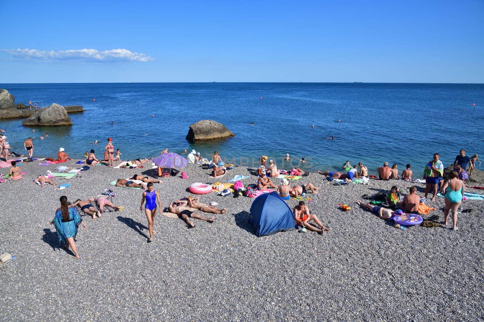 Foros, Crimea - June 30. 2019. Rocky beach with cliff in the Black Sea