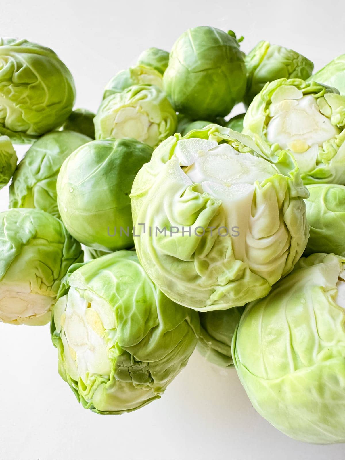 Close up of fresh green Brussels sprouts on white background. Organic vegetable, healthy food, vegan diet concept. High quality photo