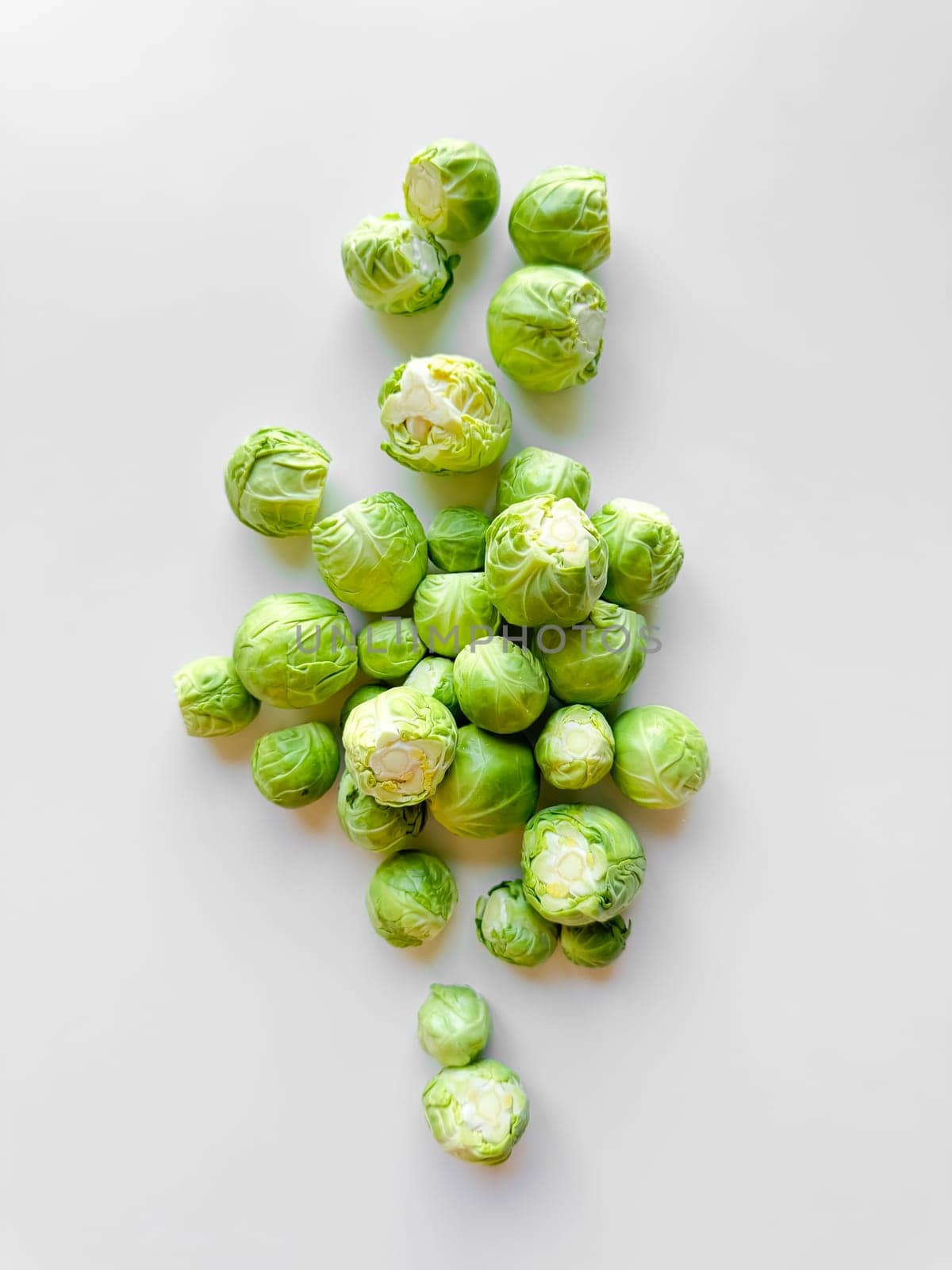 Fresh green Brussels sprouts on white background, healthy eating concept. by Lunnica