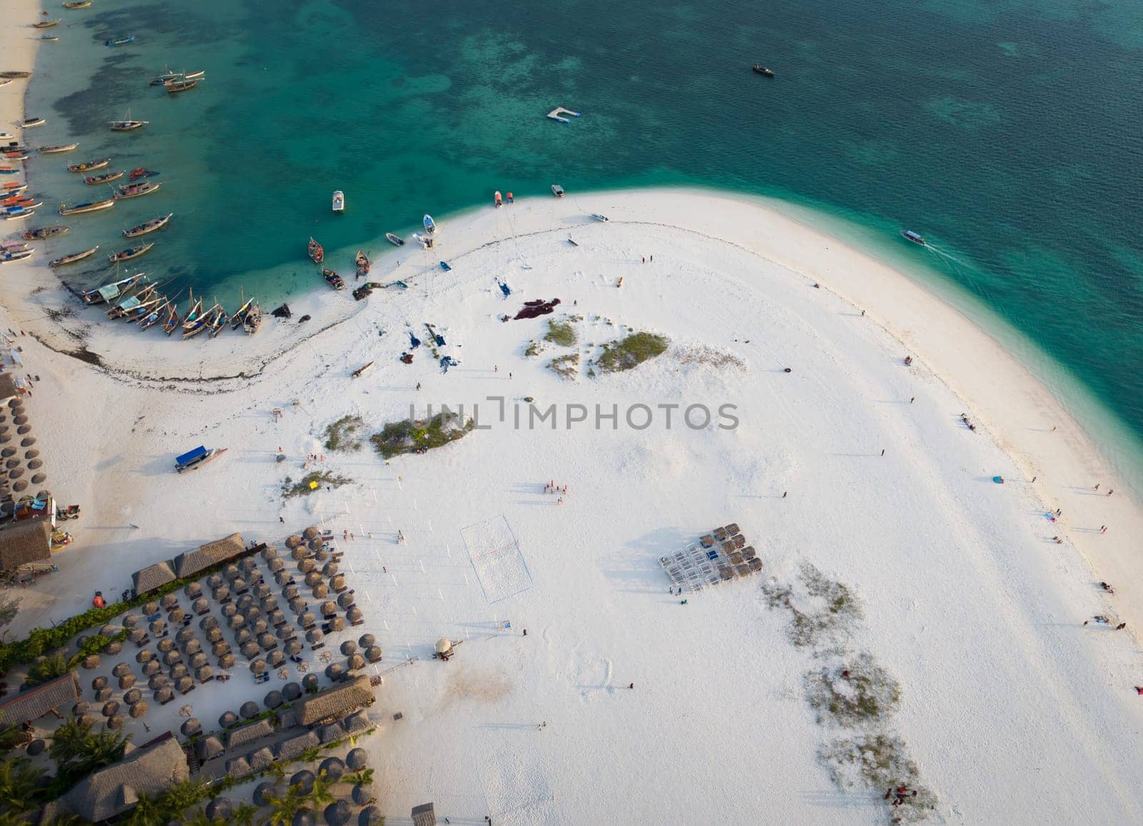 High angle of view of beach, boats and clear green water on tropical sea coast with sandy beach.Summer travel in Zanzibar, Africa,Tanzania.