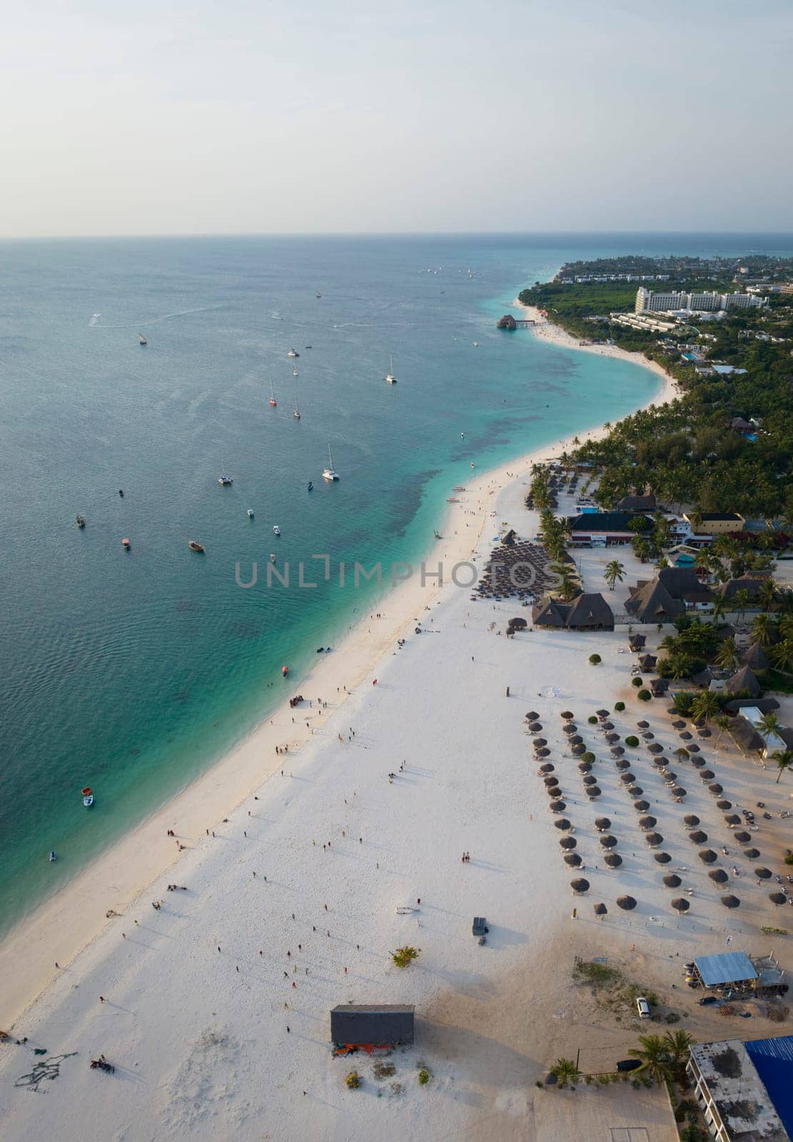 Panorama of sandy beach boats and clear green water in Zanzibar by Robertobinetti70