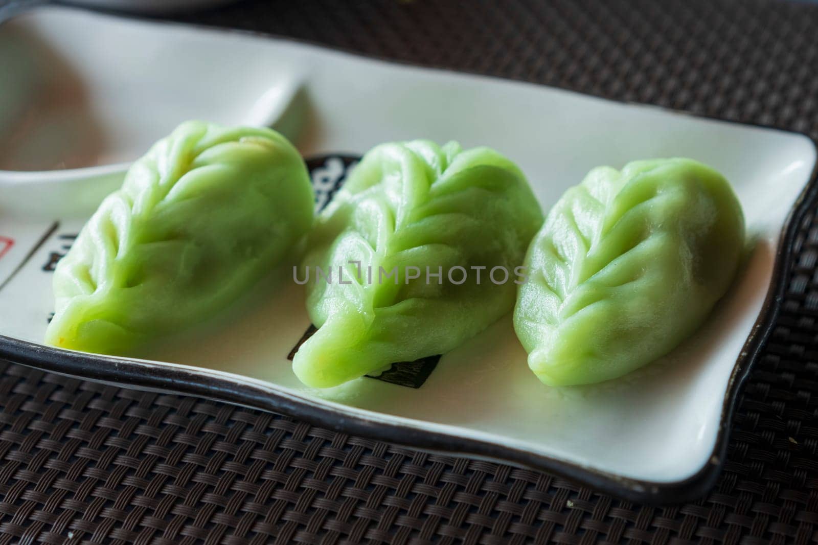 Close up of green japanese dumplings Gyoza with vegetables at restaurant by Robertobinetti70