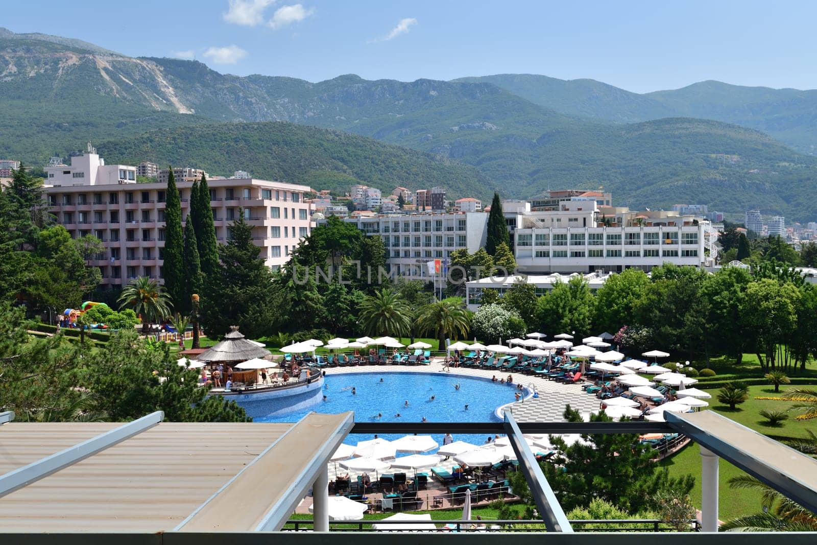 Becici, Montenegro - June 12.2019. View of pool hotel in popular resort village by olgavolodina