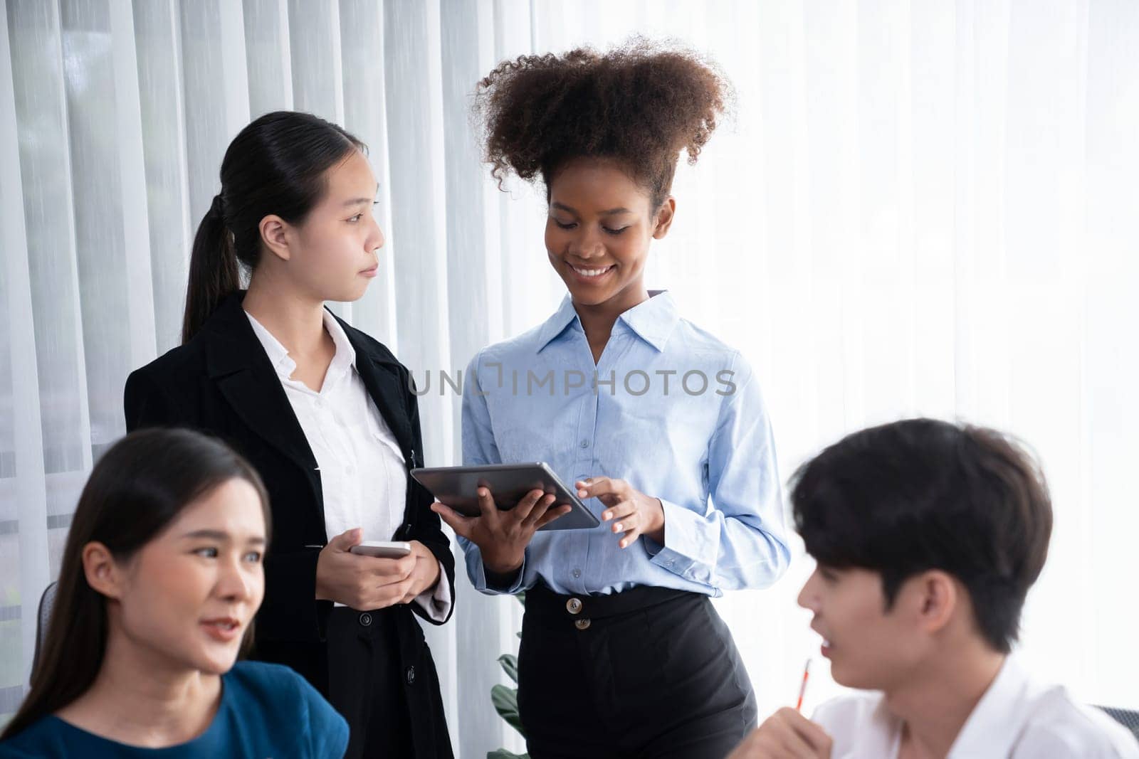 Happy diverse business people work together, discussing in corporate office. Professional and diversity teamwork discuss business plan on desk with laptop. Modern multicultural office worker. Concord