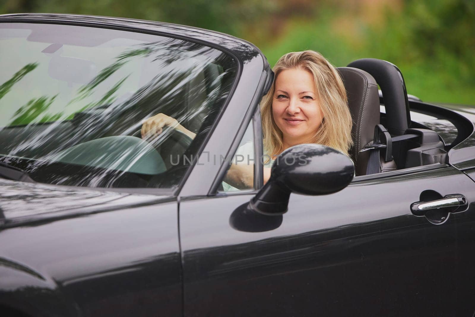 Attractive woman in a cabriolet in the Netherlands.