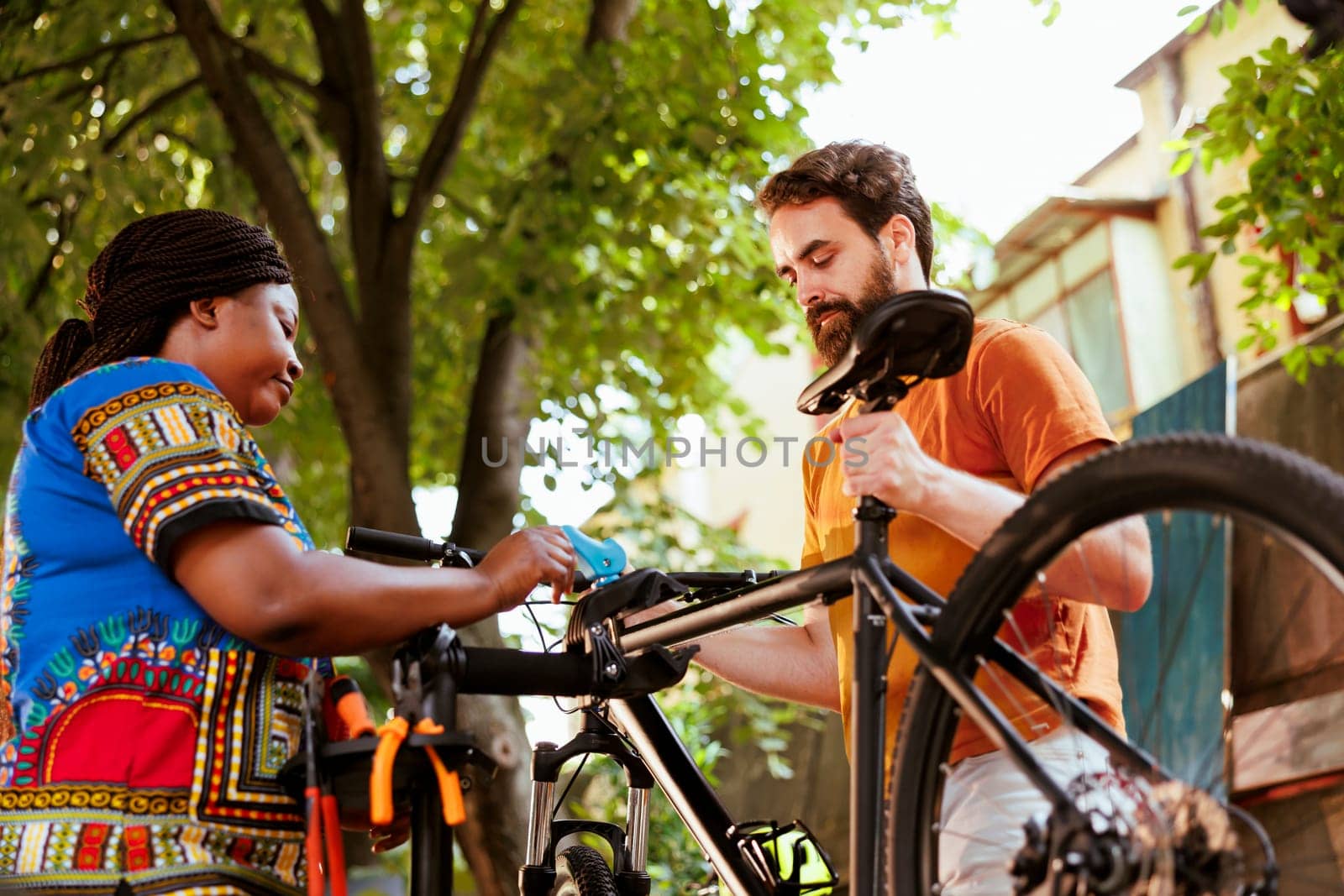 Couple fastening bicycle for repair by DCStudio