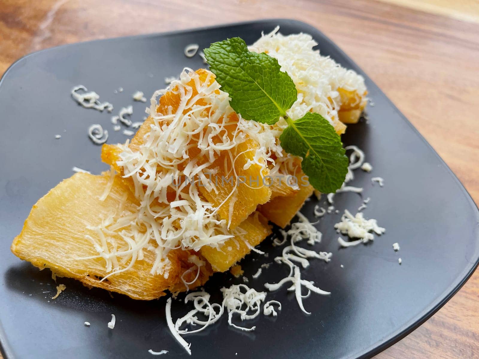 fried cassava with topping cheese on top, Indonesian traditional food, good for tea time or snack