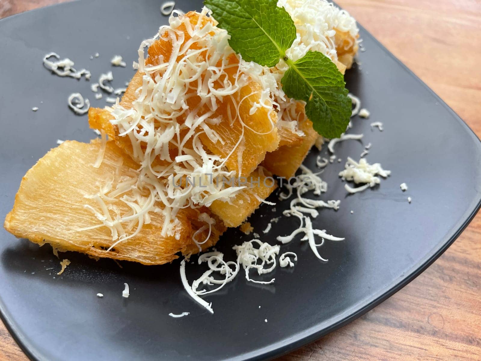fried cassava with topping cheese on top, Indonesian traditional food, good for tea time or snack