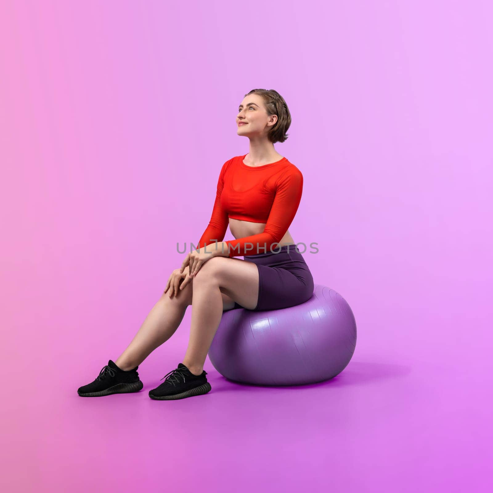 Full body length gaiety shot athletic and sporty young woman with fitness exercising ball in standing posture on isolated background. Healthy active and body care lifestyle.