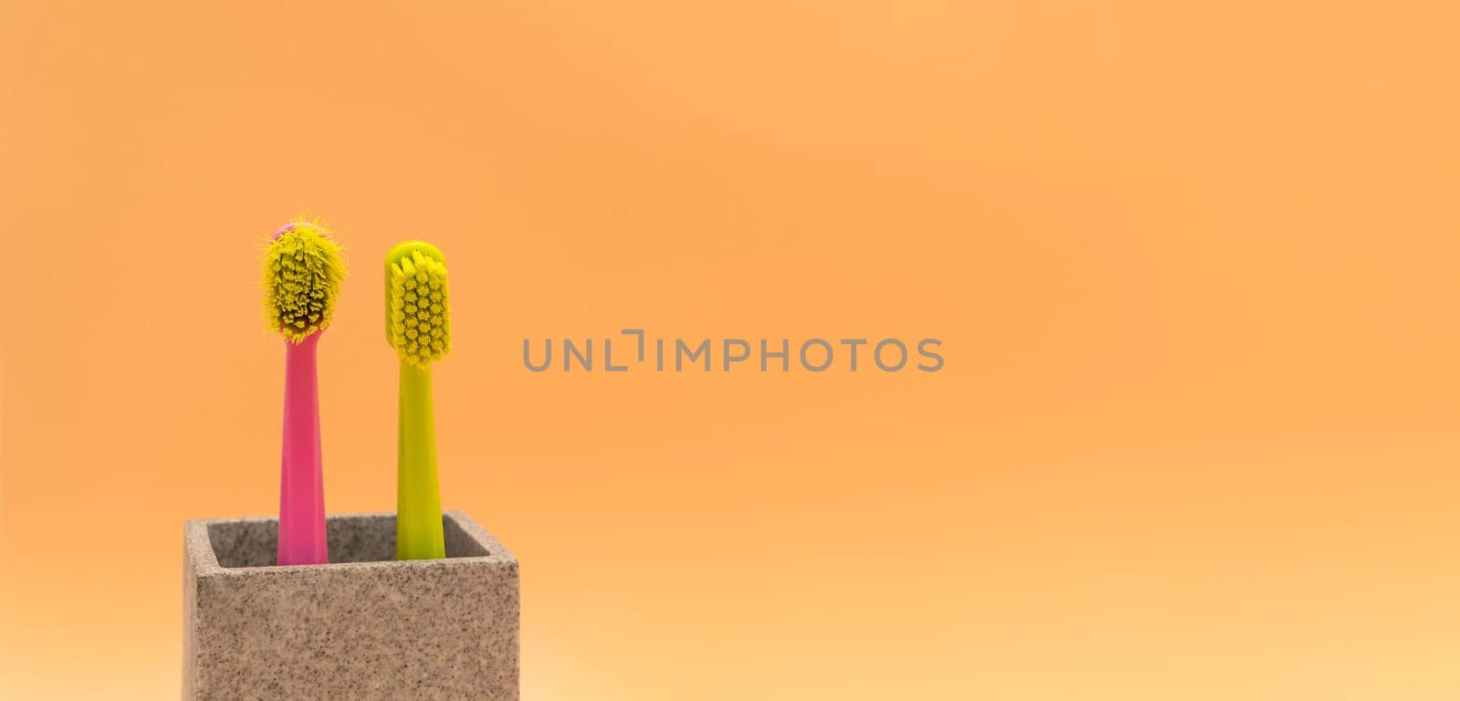 Banner Used Old And New Toothbrush On Peach Yellow Background, Empty Space For Text. Replace Old Toothbrush With A New. Personal Oral Hygiene Set. Old And New Toothbrushes Horizontal Plane.