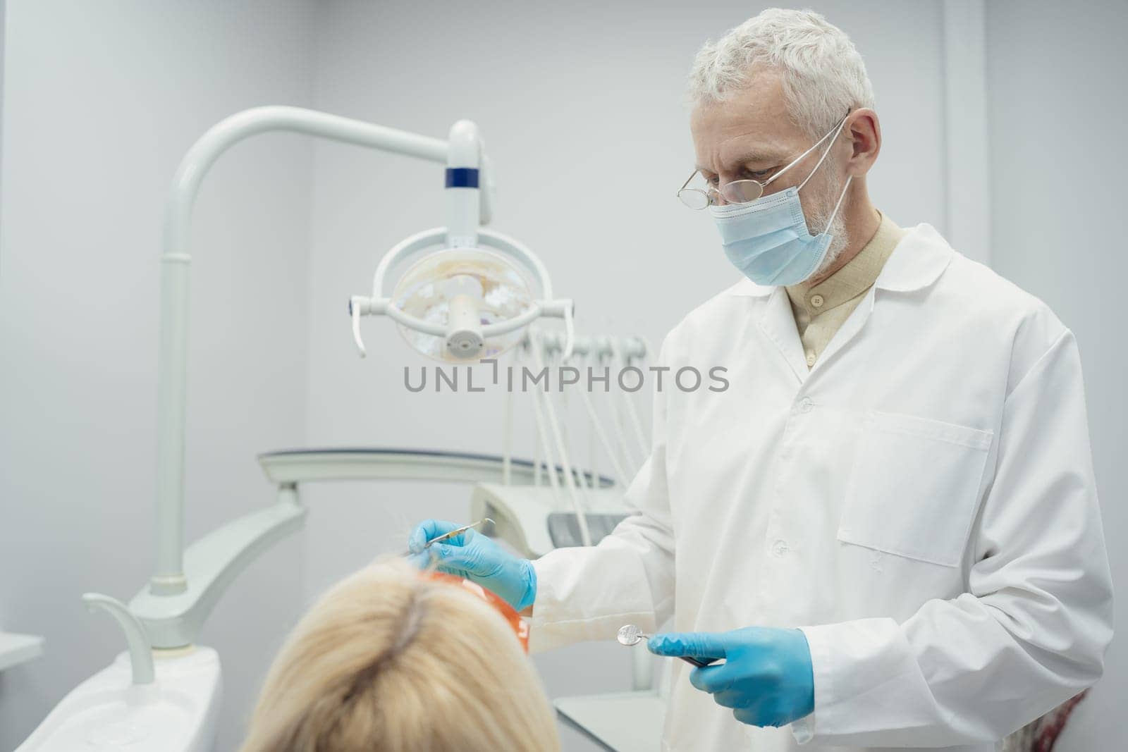 Woman smiling during her dental treatment at dentist.