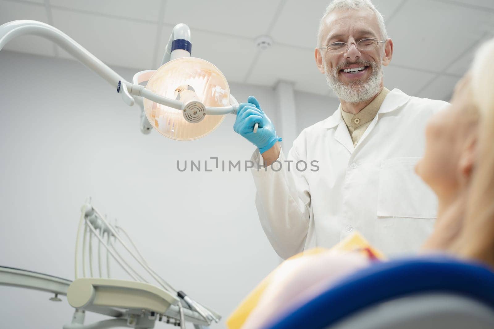 Woman smiling during her dental treatment at dentist.