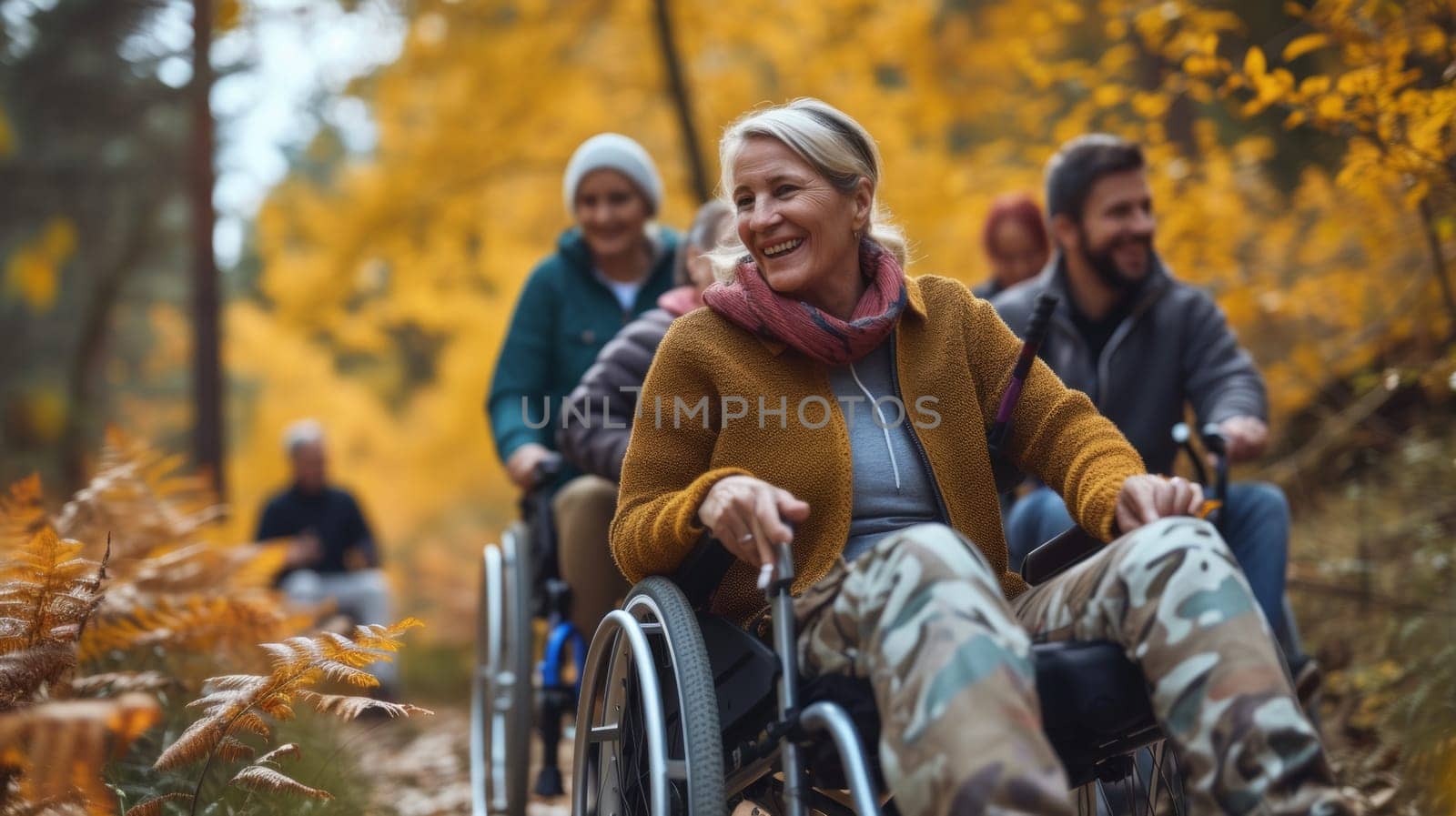 A group of people in wheelchairs on a trail through the woods