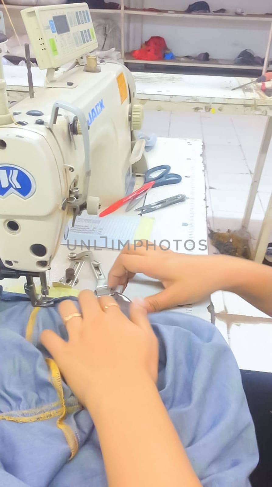 Surakarta, Indonesia, January 16, 2015, Asian garment workers sewing or stitching clothes production line of factory in Surakarta, Central Java, Indonesia