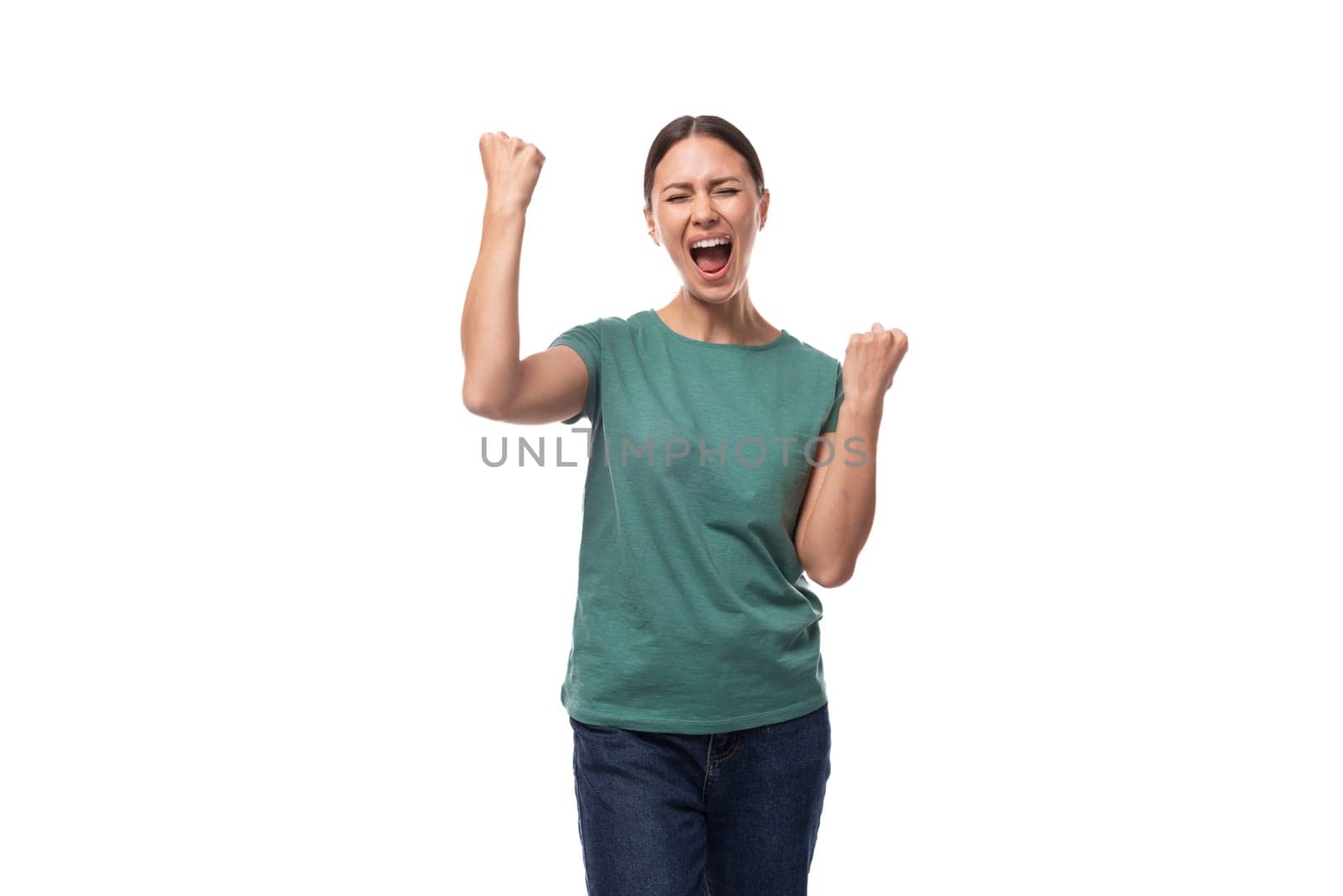 young emotional brunette woman in a t-shirt and jeans on a white background with copy space by TRMK