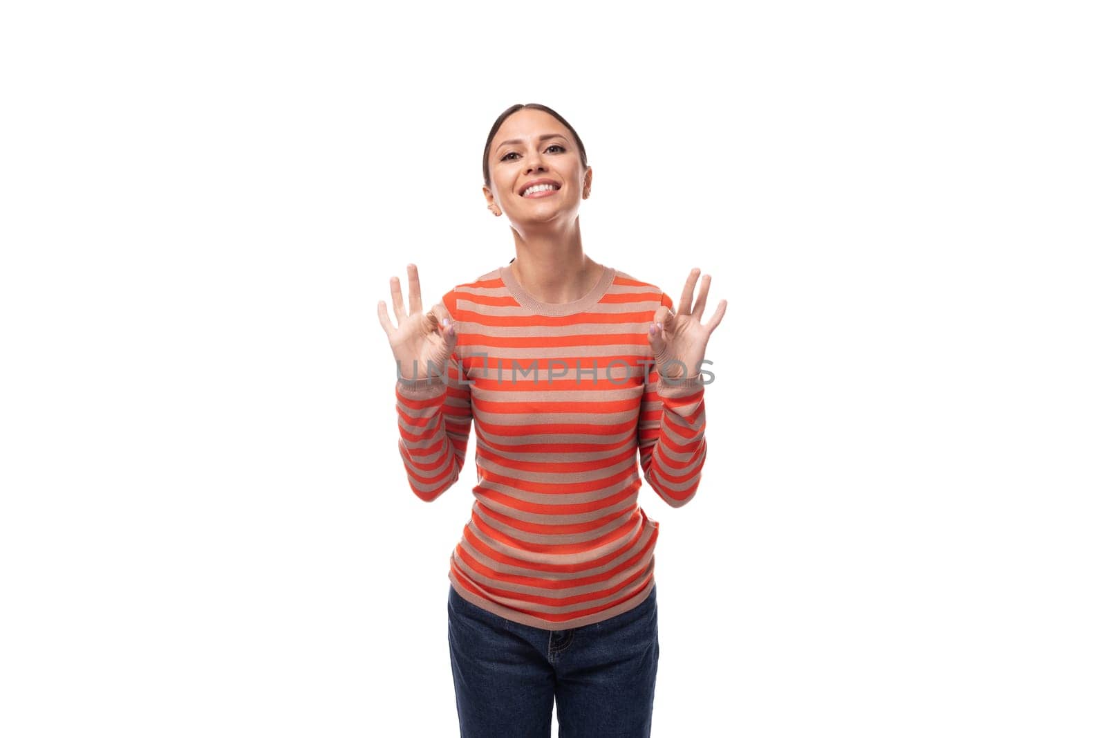 portrait of a young friendly brunette lady dressed in a casual striped blouse on an isolated white background with copy space by TRMK