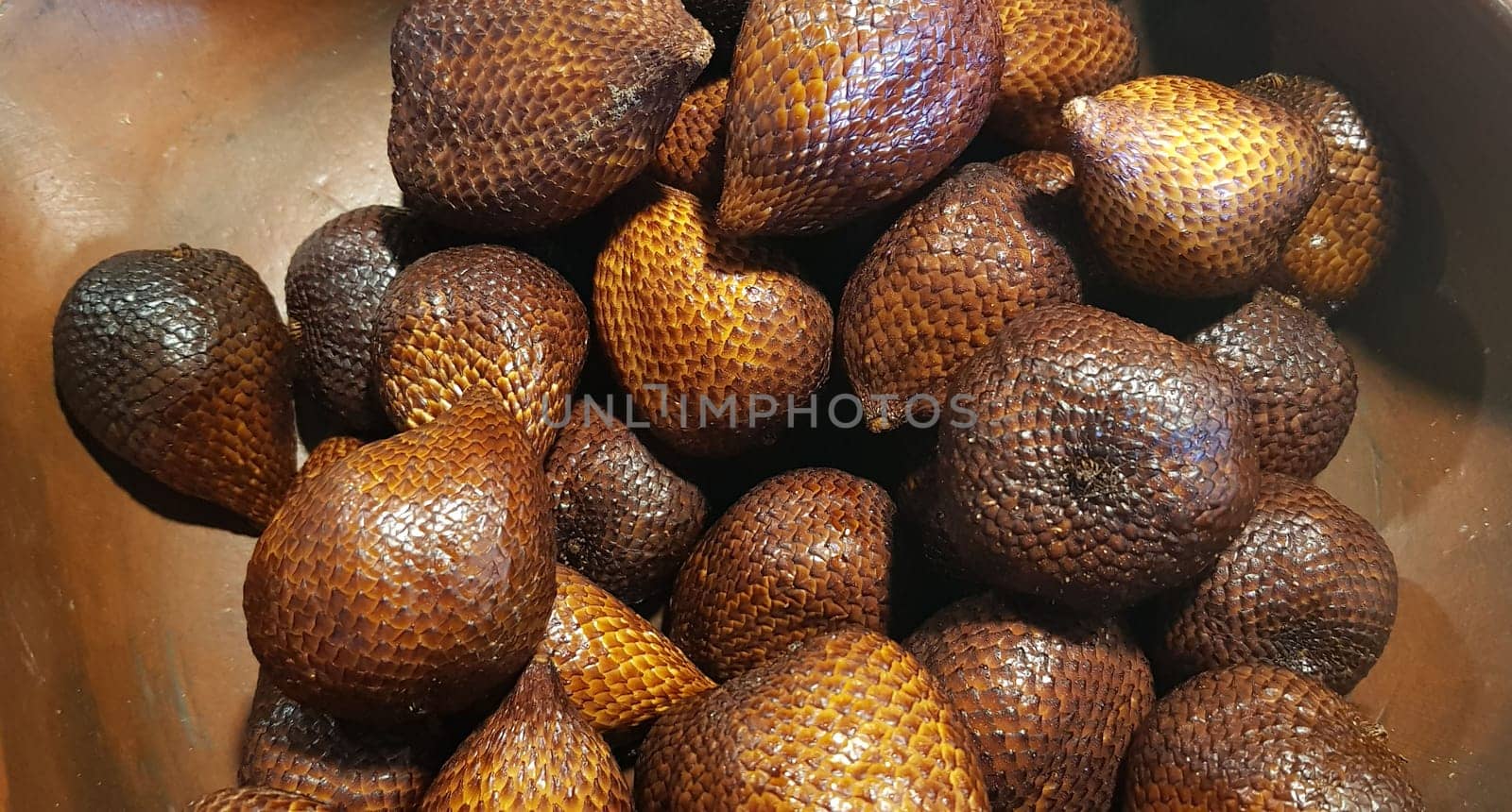 group of snake fruit or called salak in local indonesian language is a type of palm fruit commonly eaten also known as sala, the scientific name is Salacca zalacca.