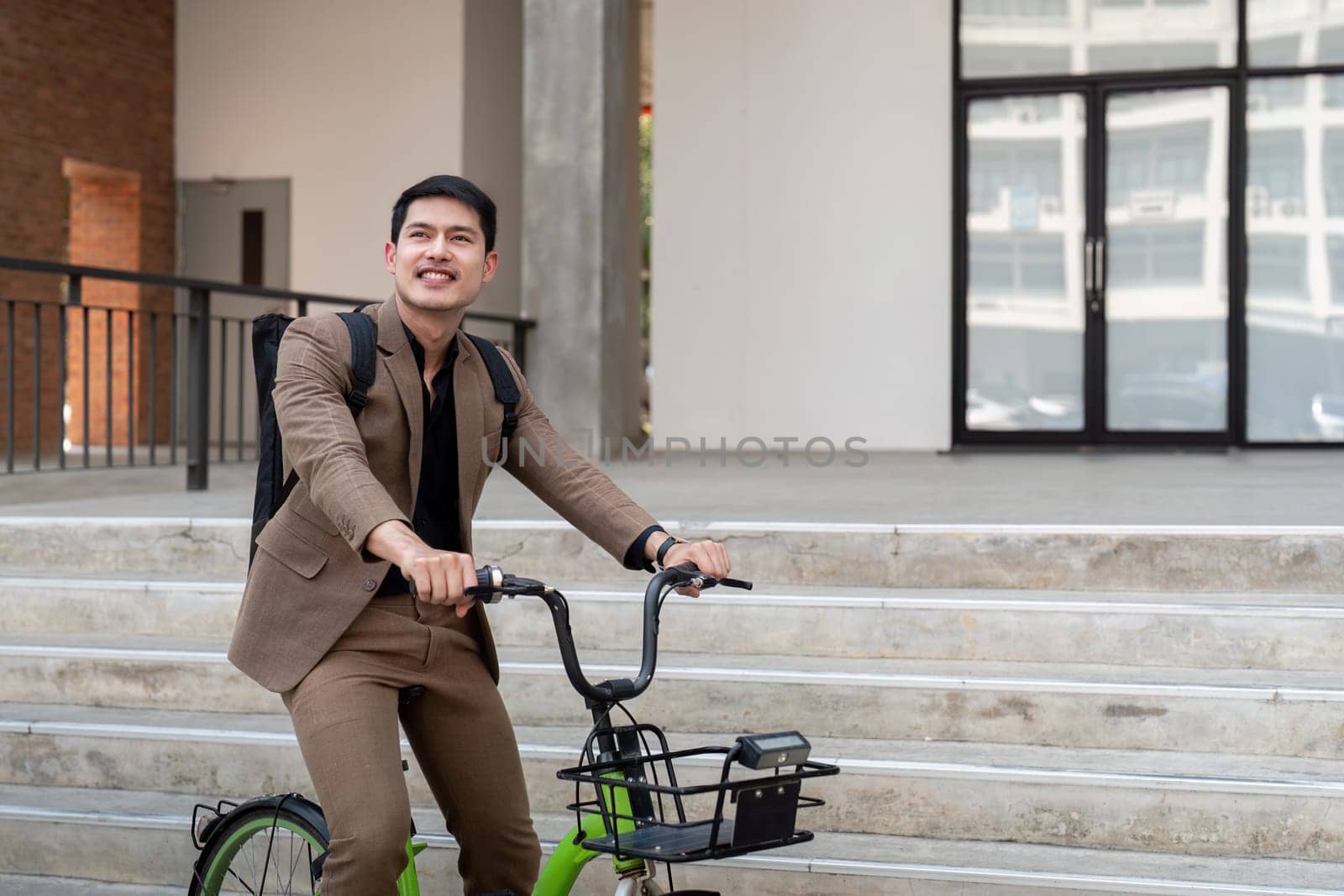 The businessman eco friendly transportation, cycling through the city avenues to go to work. sustainable lifestyle concept by nateemee