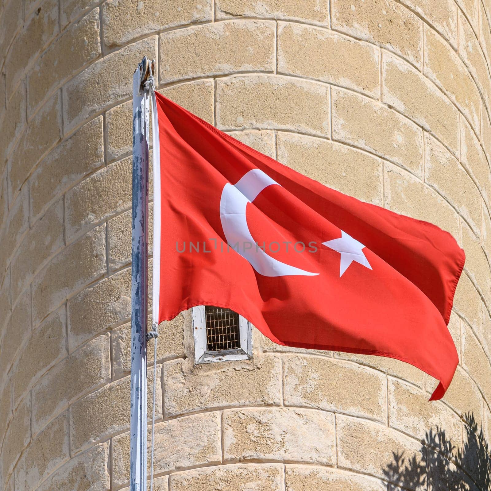 Turkish flag on the background of a brick wall of the mosque 2