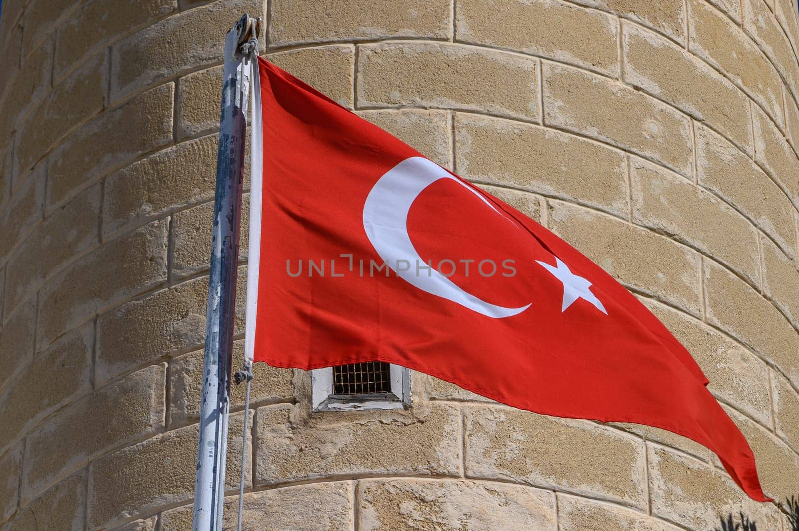 Turkish flag on the background of a brick wall of the mosque