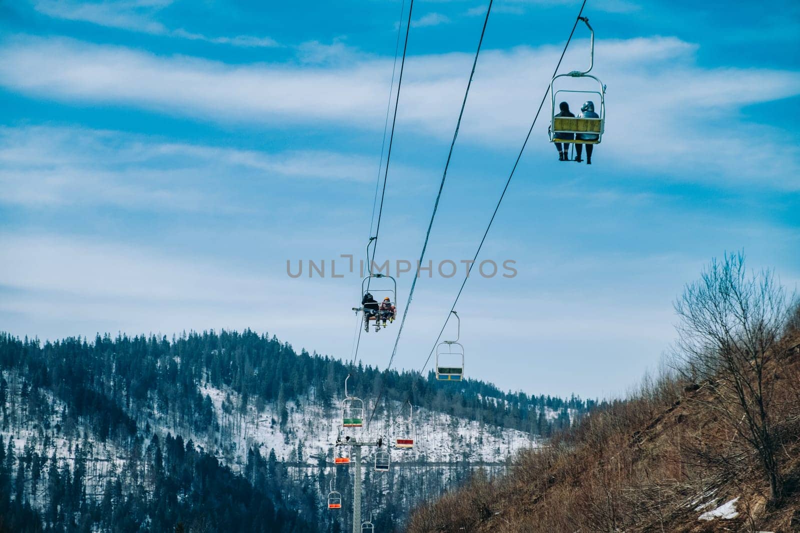 mountains in snow with ski lift chairs. download by igor010