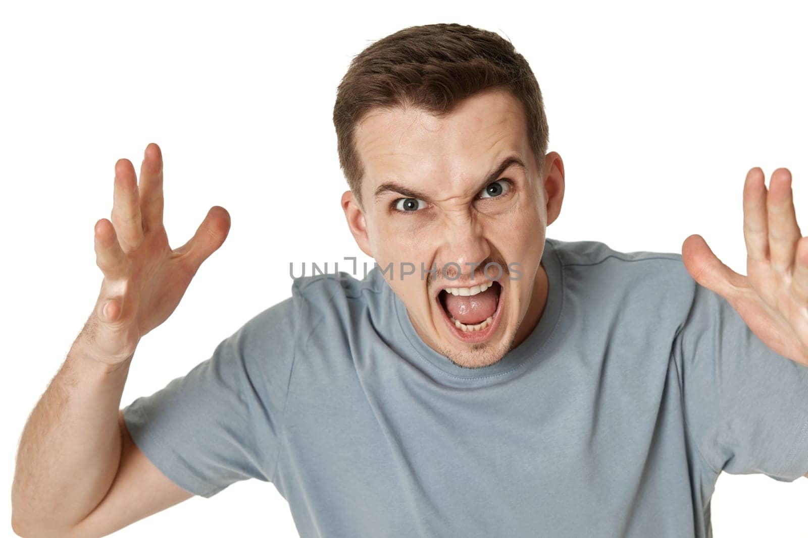 annoyed angry bearded man shouting on white studio background