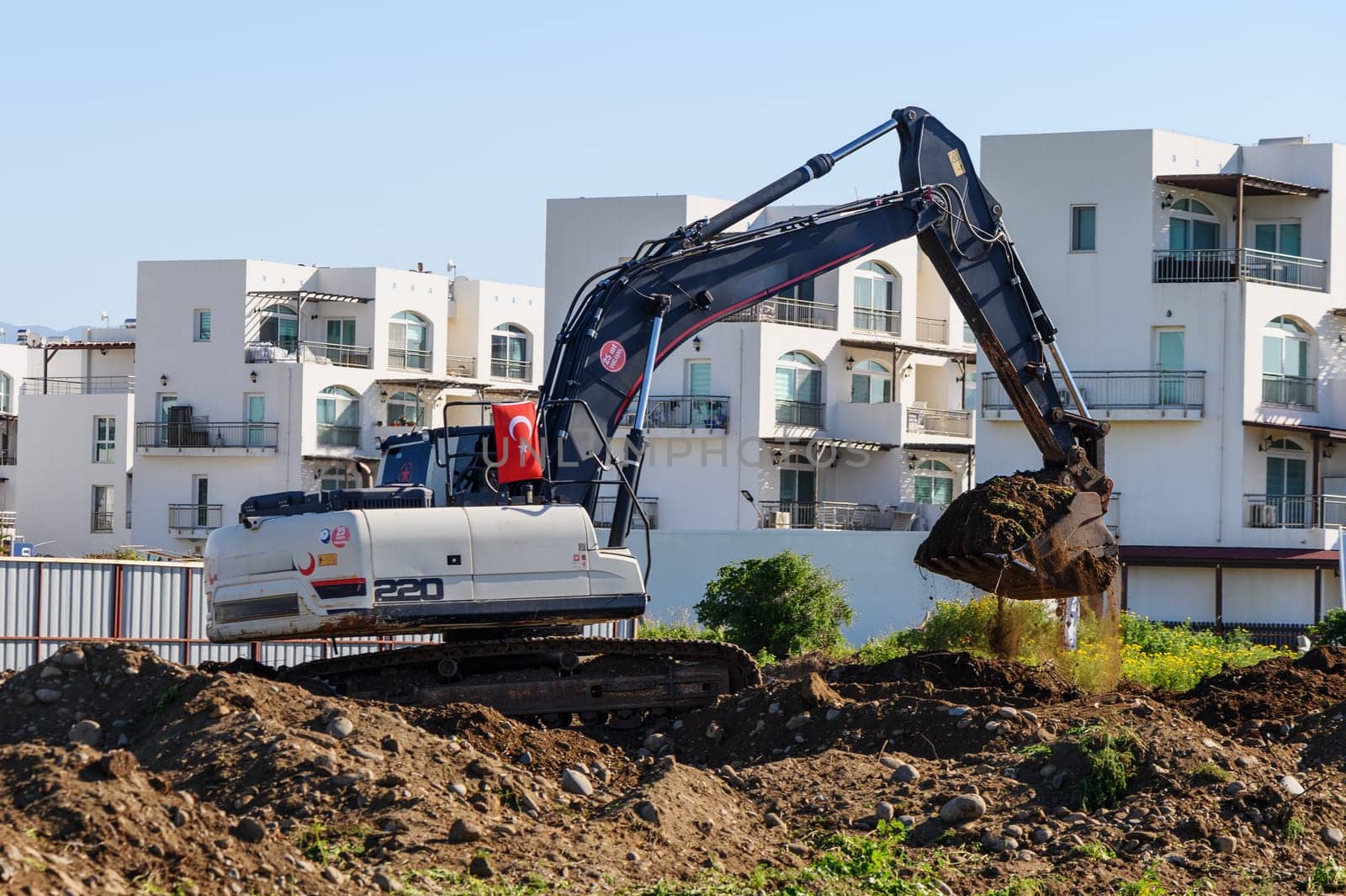 Excavator digging soil at a construction site