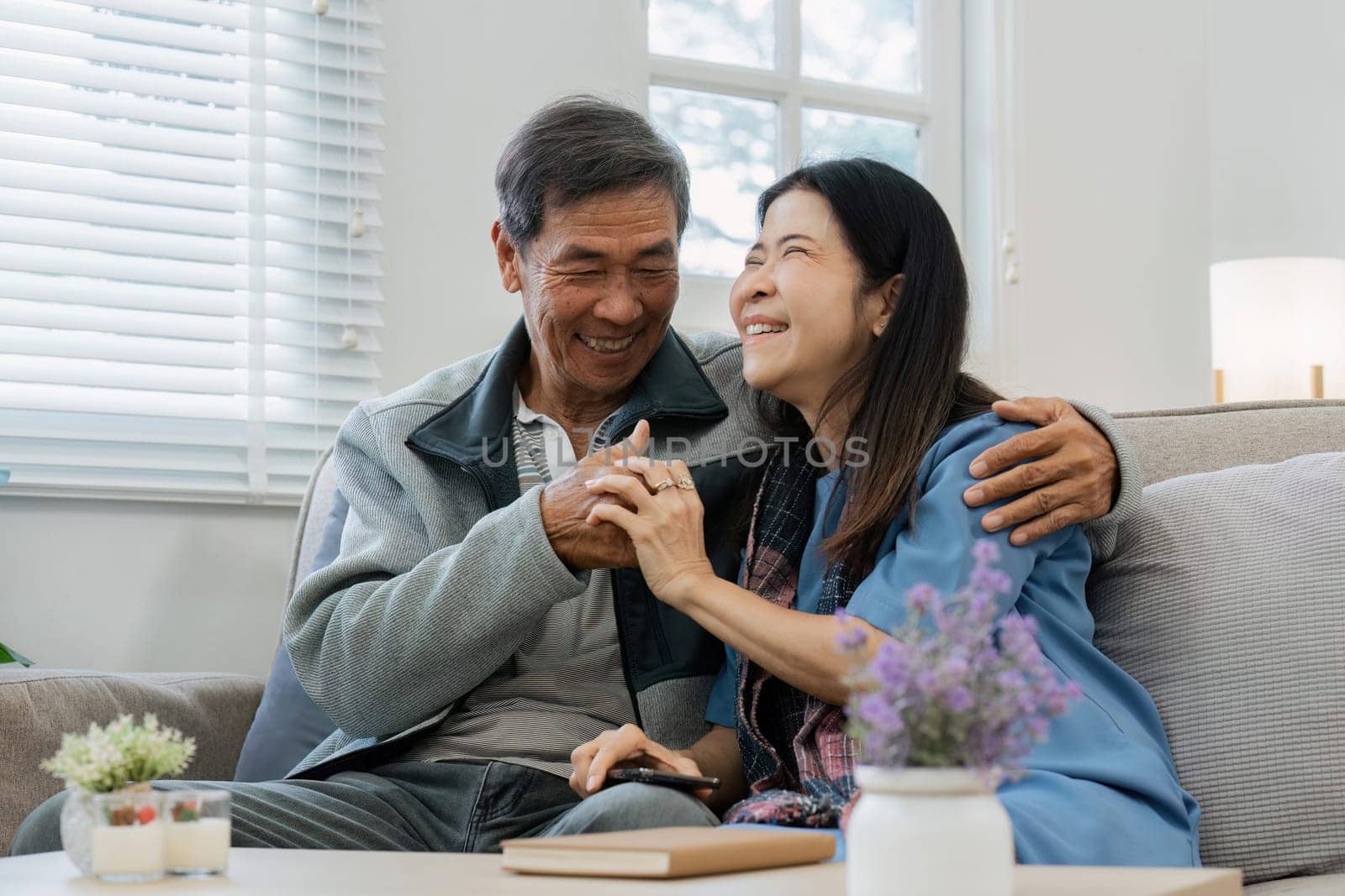 Relax, home and mature couple on sofa hug for bonding, healthy relationship and marriage. Retirement, happy by itchaznong