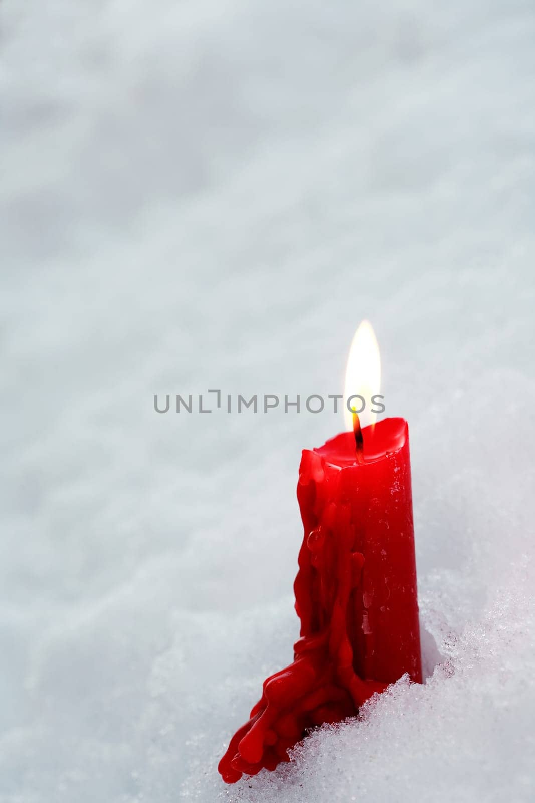A symbol of memory. A single candle burns in the snow