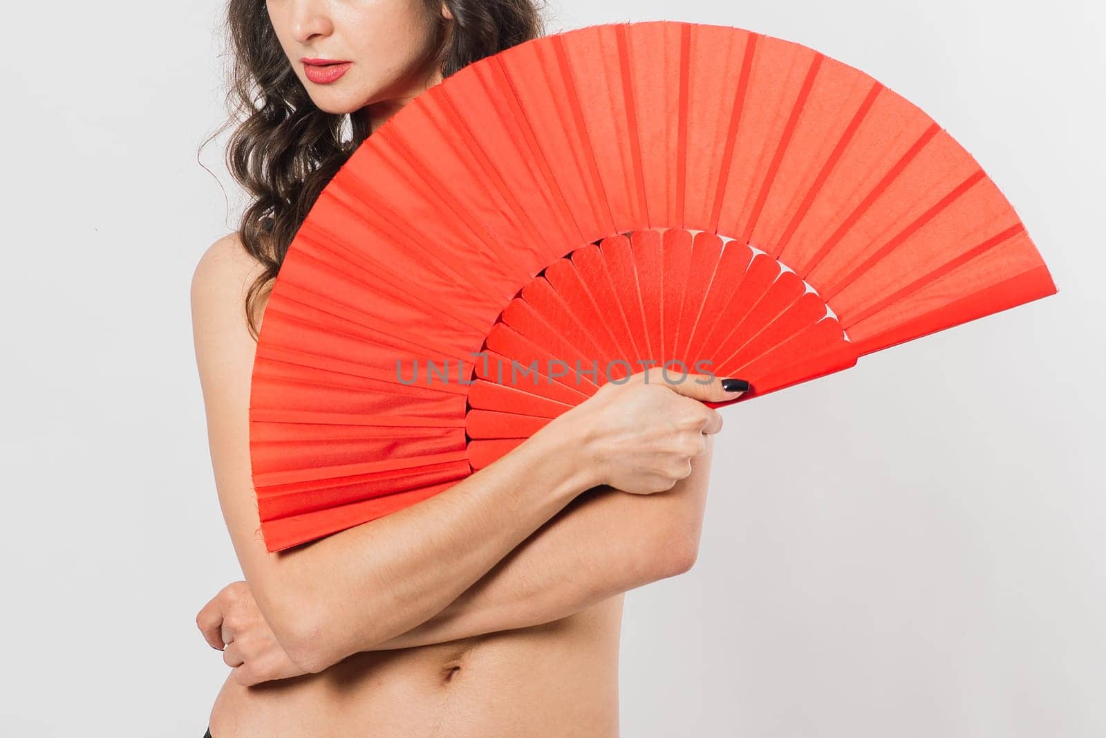 Dancer female with a fan in lingerie, nude