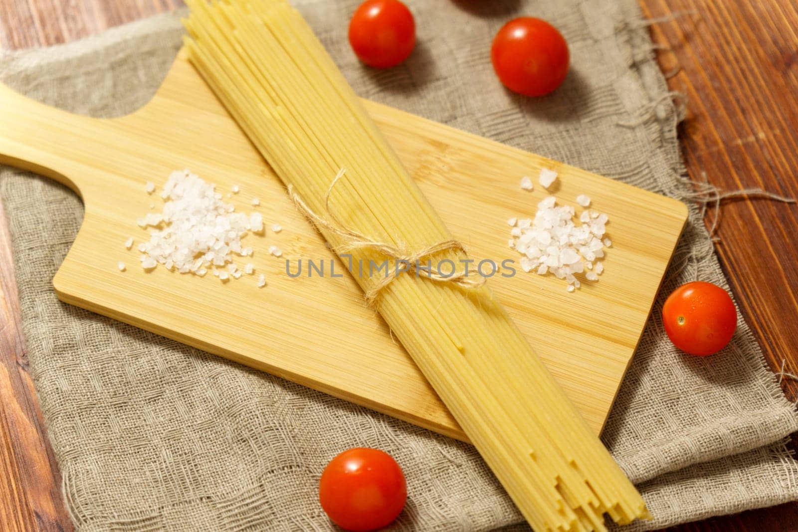 Italian raw spaghetti, close-up, macro. Italian cuisine or culinary concept. Selective focus