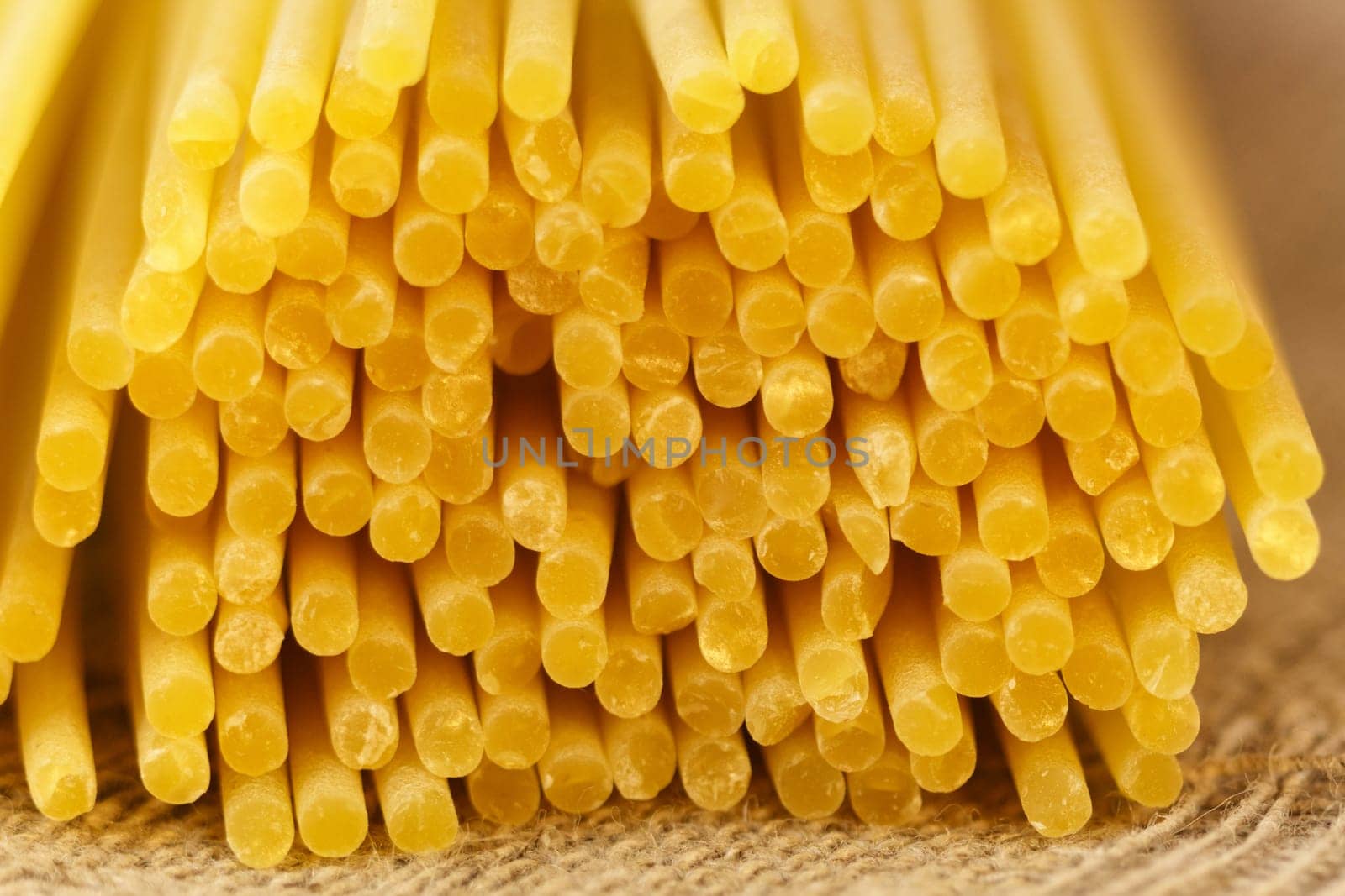 Italian raw spaghetti, close-up, macro. Italian cuisine or culinary concept. Selective focus