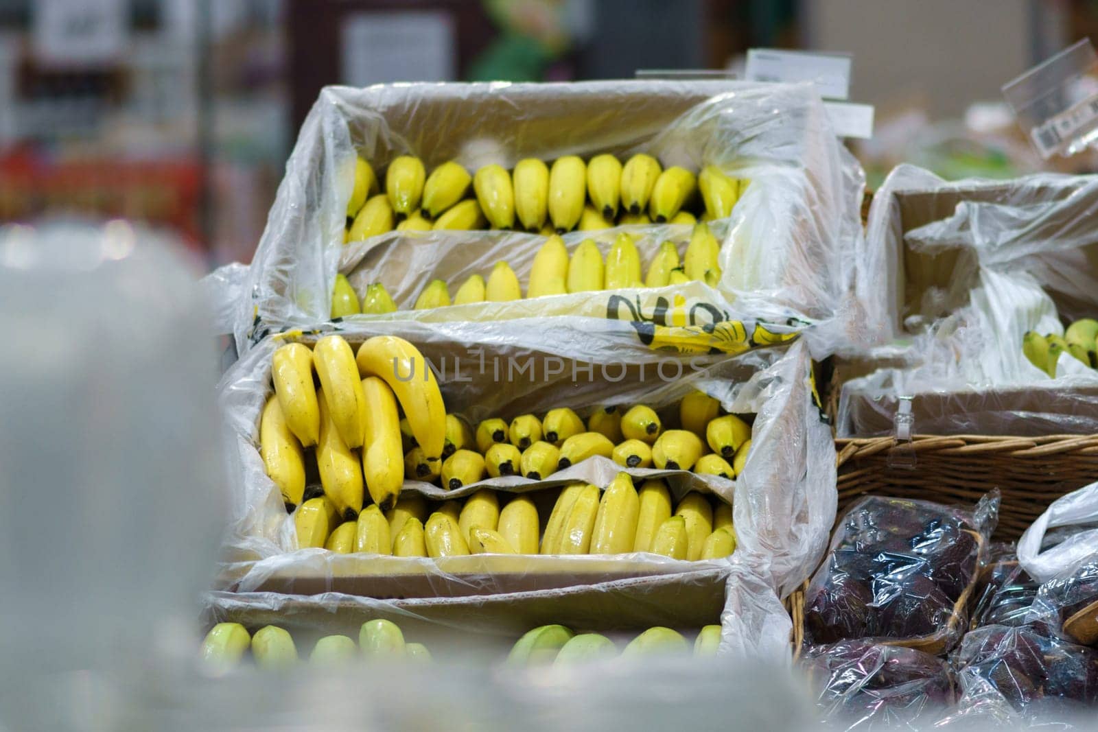 Ripe yellow bananas on the shelves of a hypermarket. Healthy food. shopping concept by darksoul72