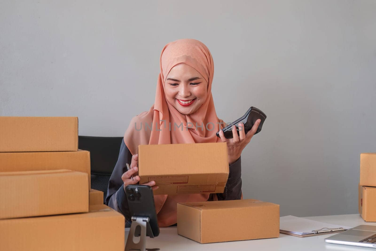 Beautiful Muslim woman selling online at home, business owner, business start up small business concepts.